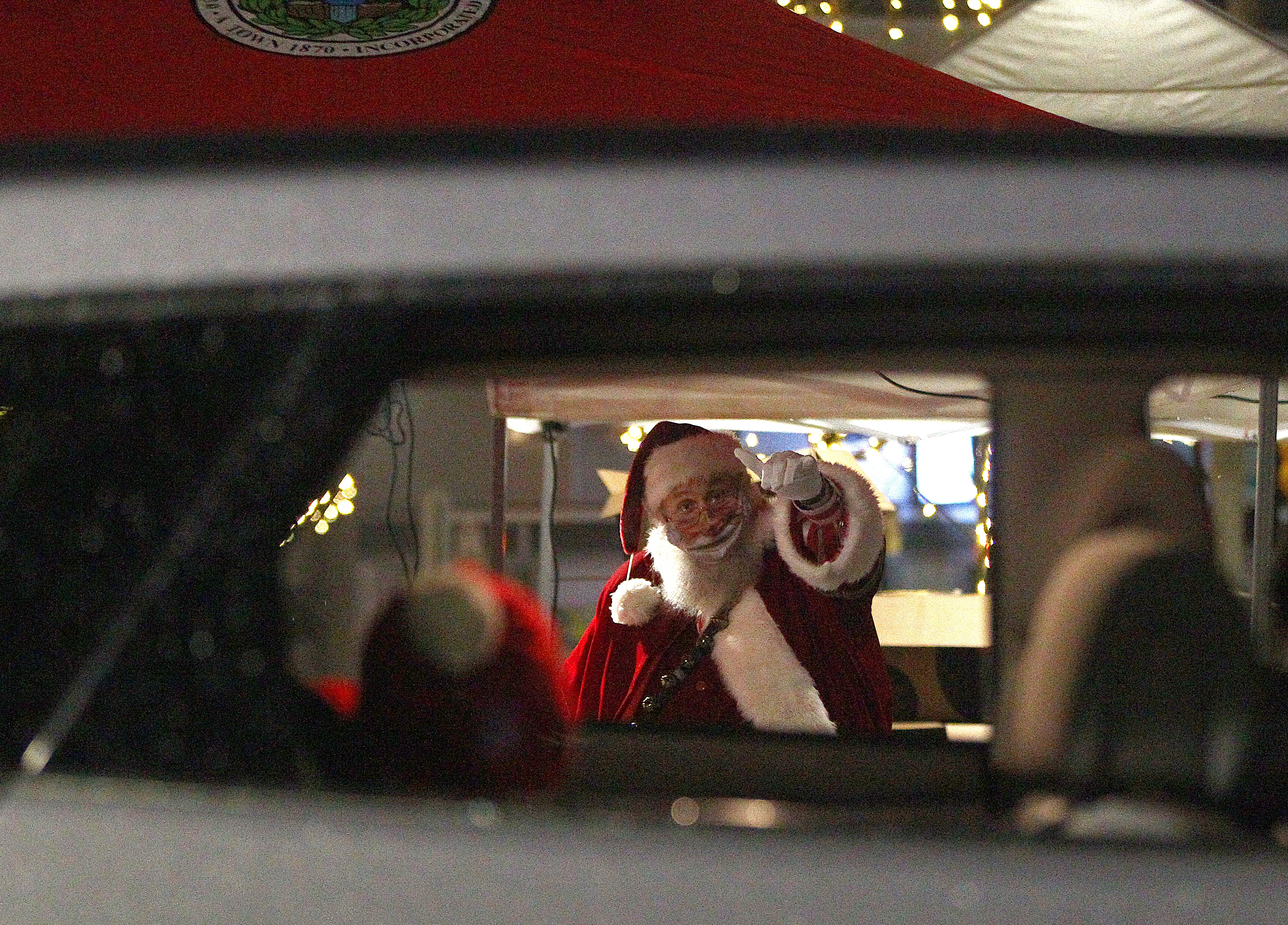 Santa waved to the children in the rear of this vehicle at the Winter Wonderland drive-thru around Wehner Park in Everett.
