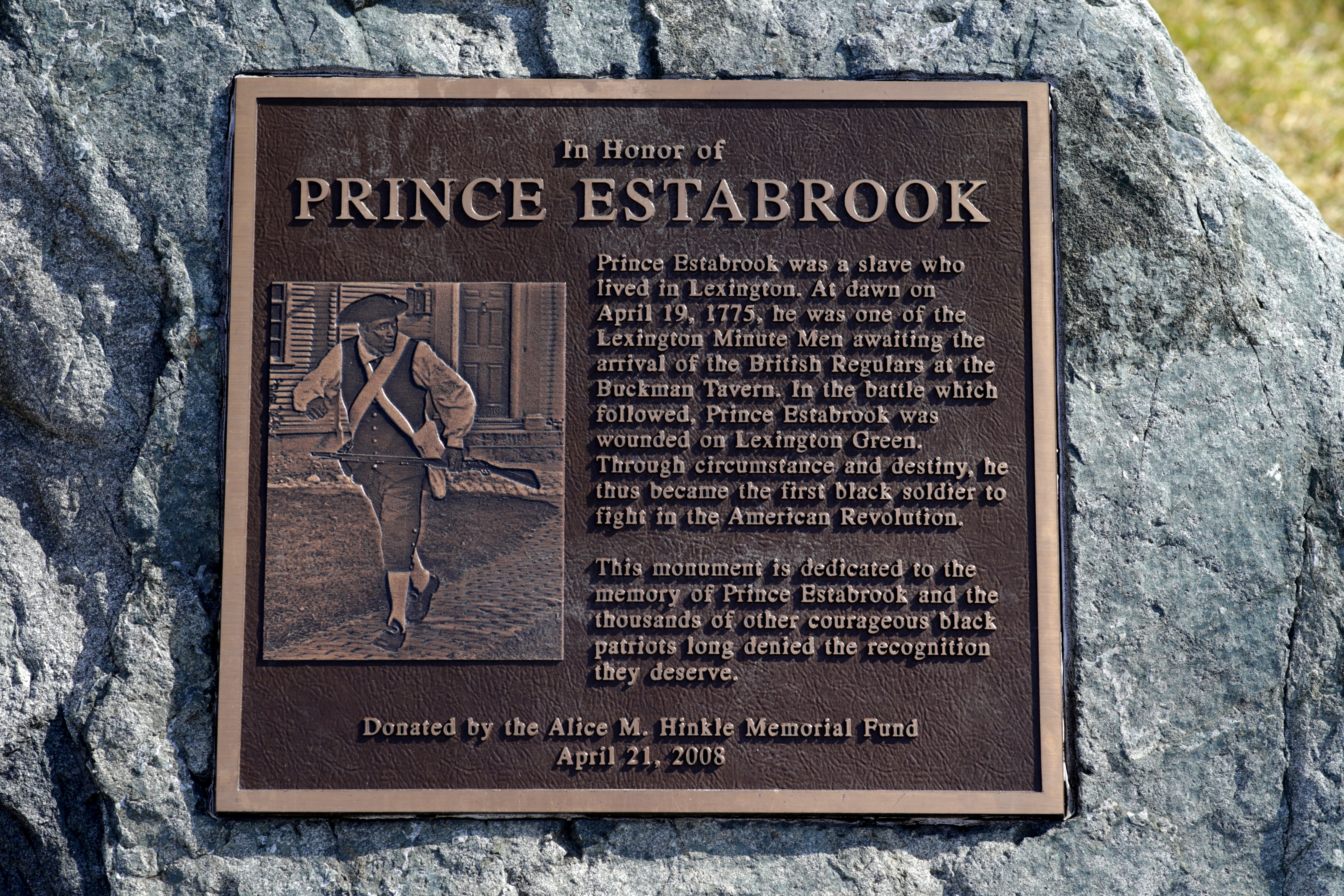The life of Prince Estabrook, an enslaved man who served as a member of the Lexington militia, is commemorated by a plaque outside the Buckman Tavern.