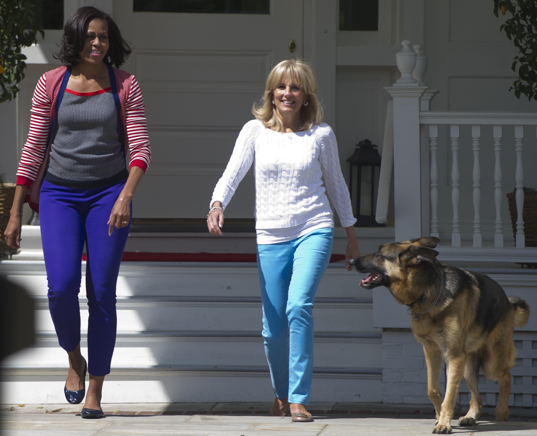 In this May 2012 photo, first lady Michelle Obama and Jill Biden, wife of US Vice President Joe Biden, and their dog Champ, at the Naval Observatory in Washington, D.C.