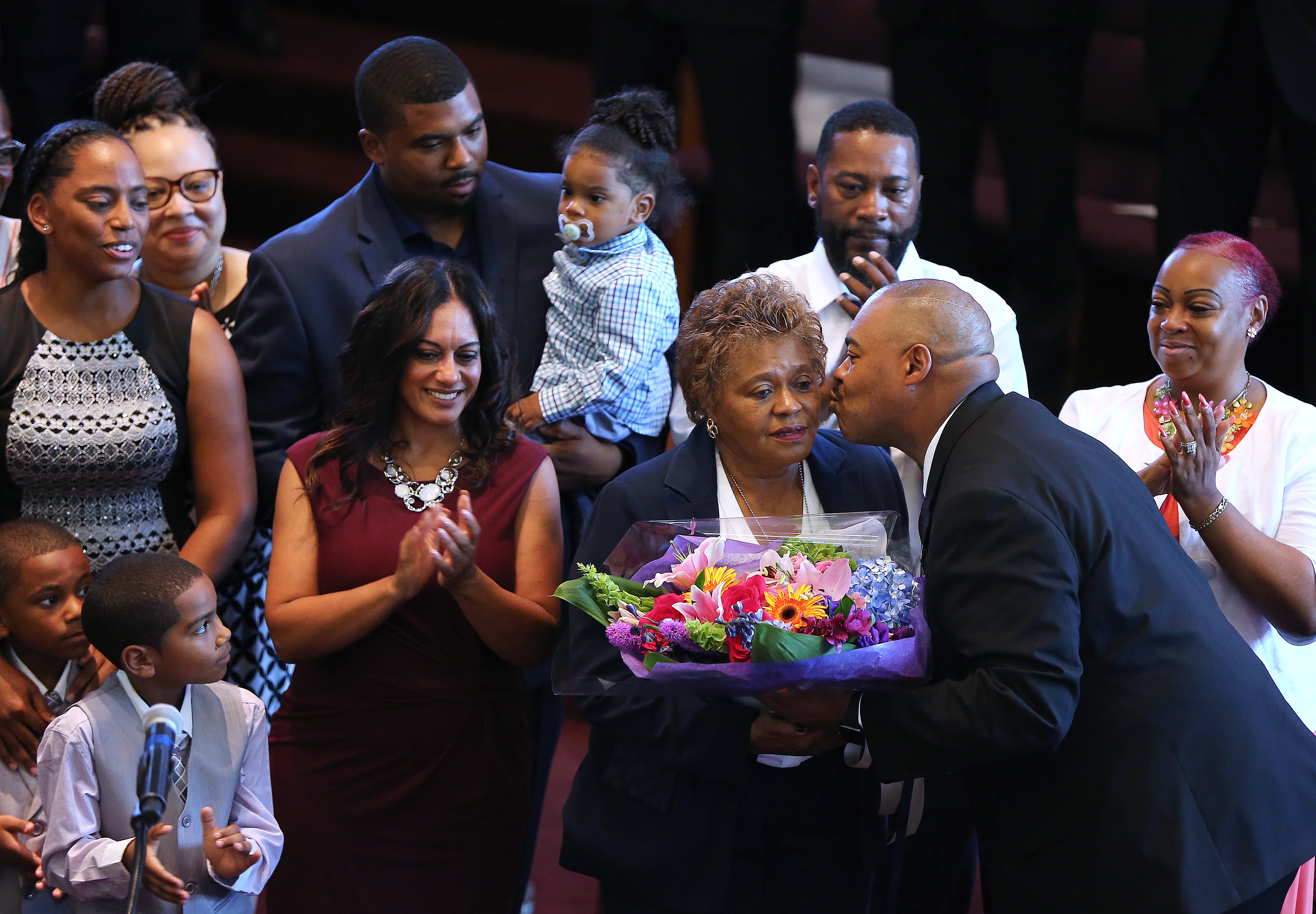 After William G. Gross was pinned by his mother Deanna Gross, he put the badge around her neck and then gave her a bouquet of flowers.