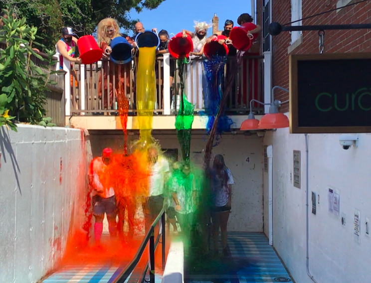 Curaleaf employees at the company's Provincetown store on Commercial Street get doused with rainbow-colored "Pride" water in August.