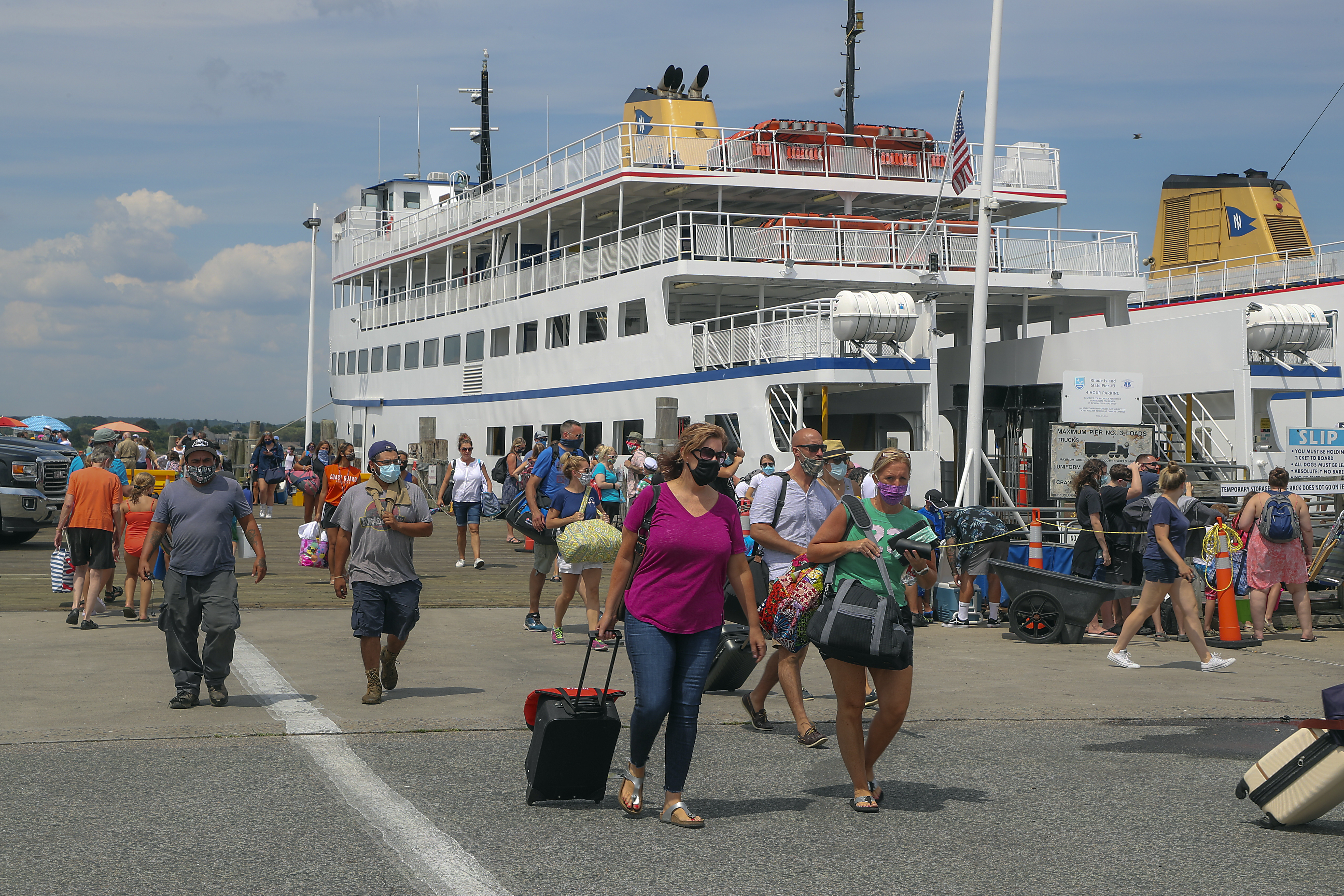Travelers leaving and arriving on the Block Island ferry Friday.