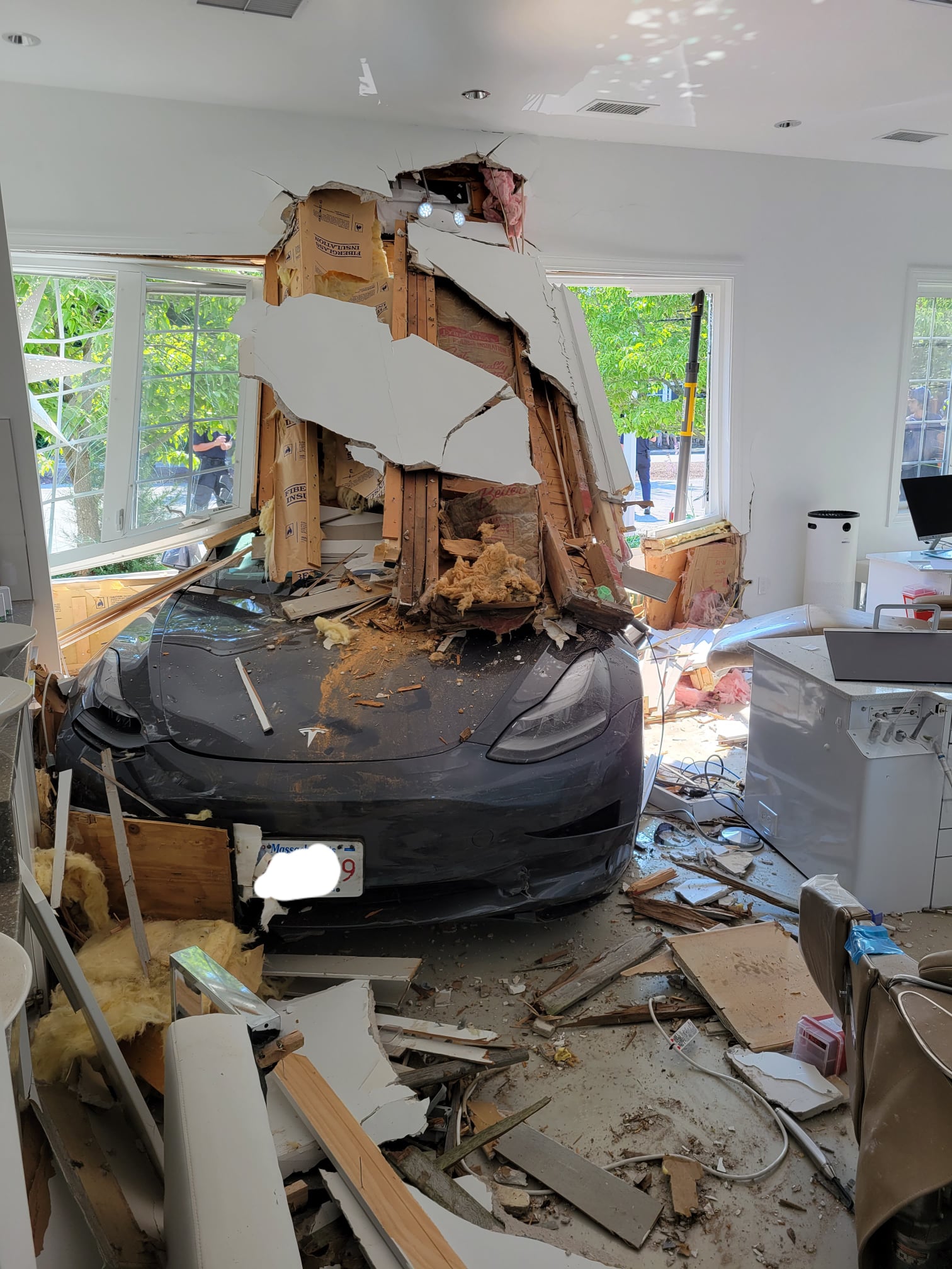 A woman crashed her vehicle into the living room of a home in Attleboro attempting to flee the scene of a hit-and-run.
