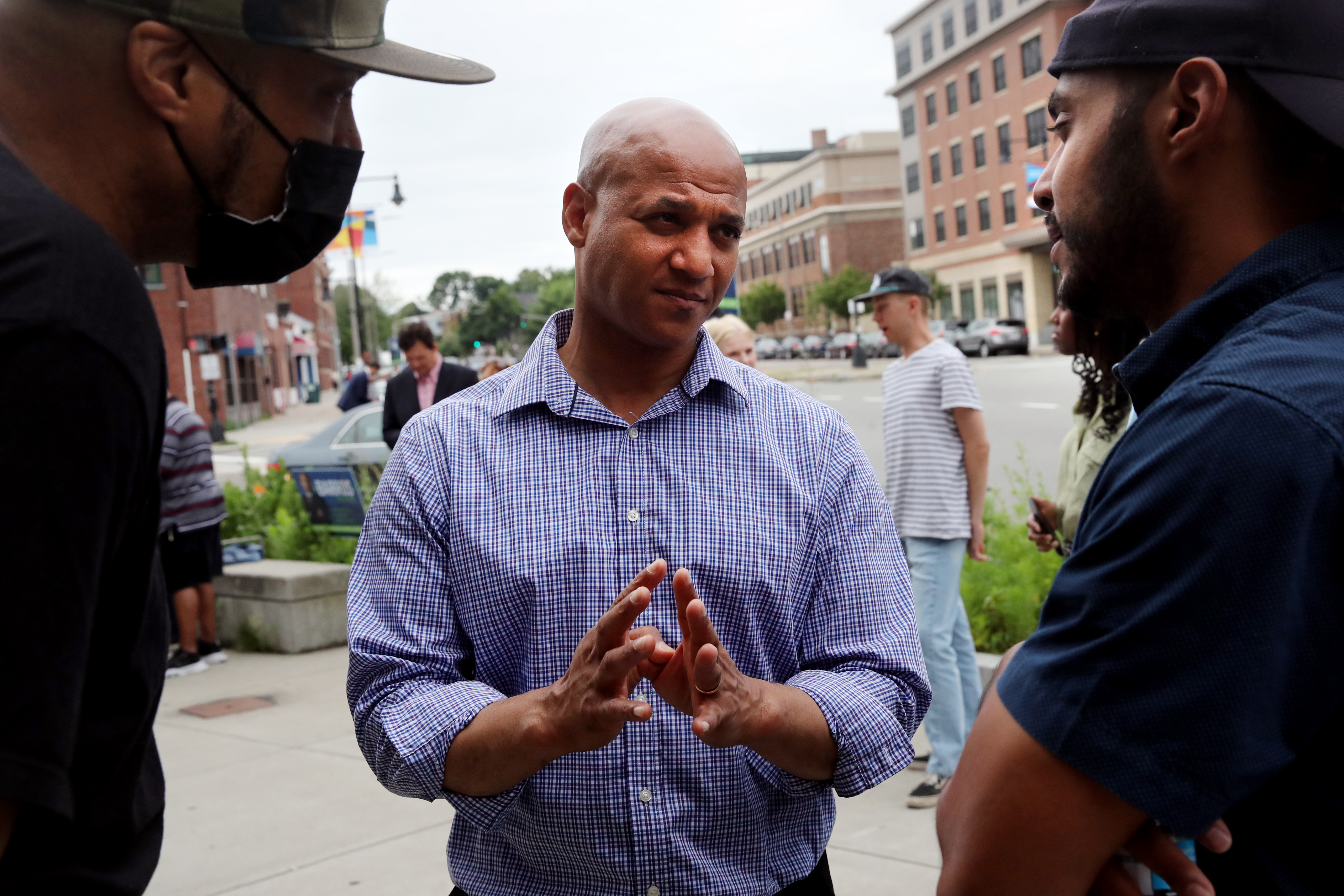 Mayoral candidate John Barros talked with his supporters during a July campaign event outside Boston Pizza and Grill in Dorchester.