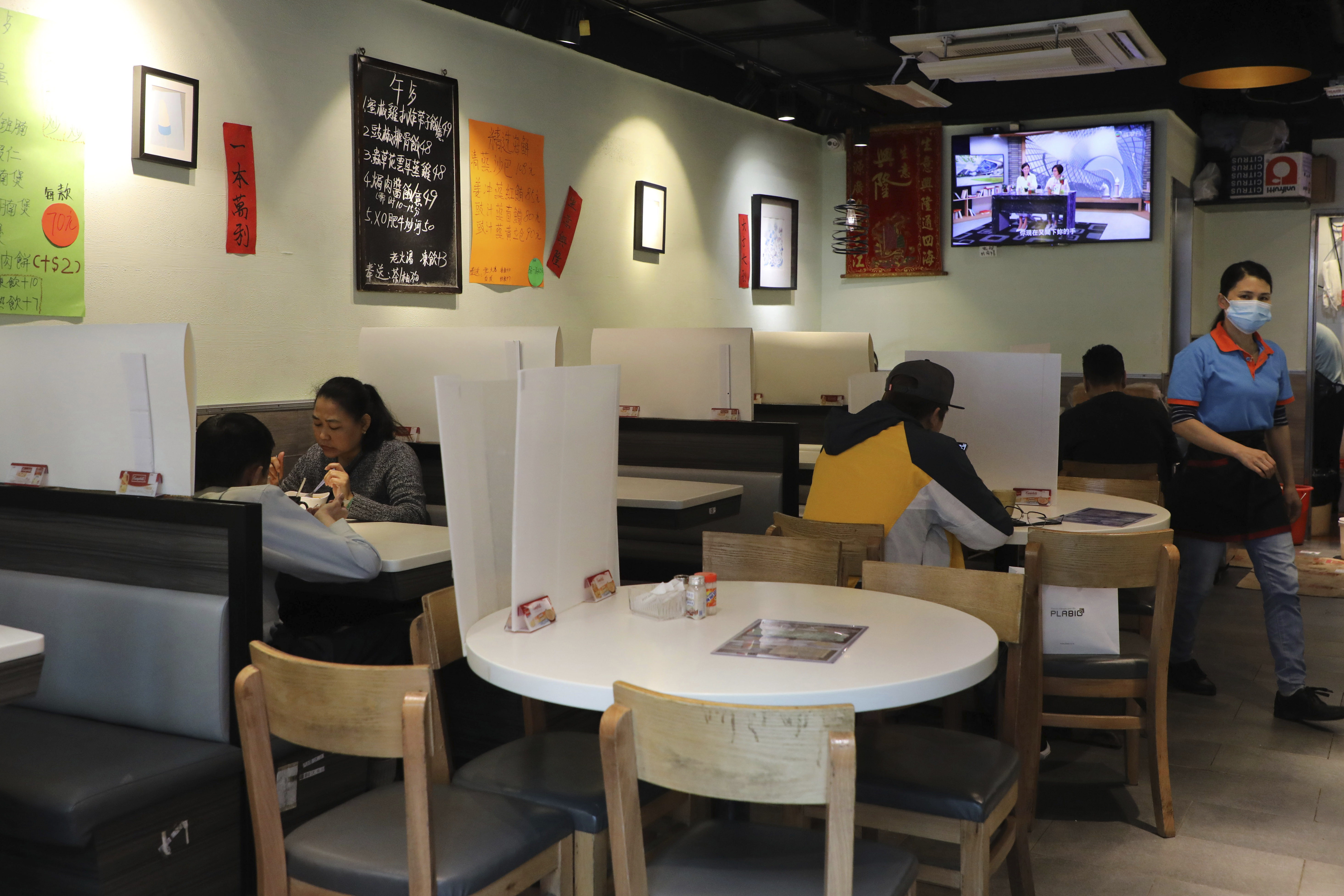 Customers ate breakfast with plastic panels setup on the tables to protect themselves from possibly contracting the coronavirus at a restaurant in Hong Kong.