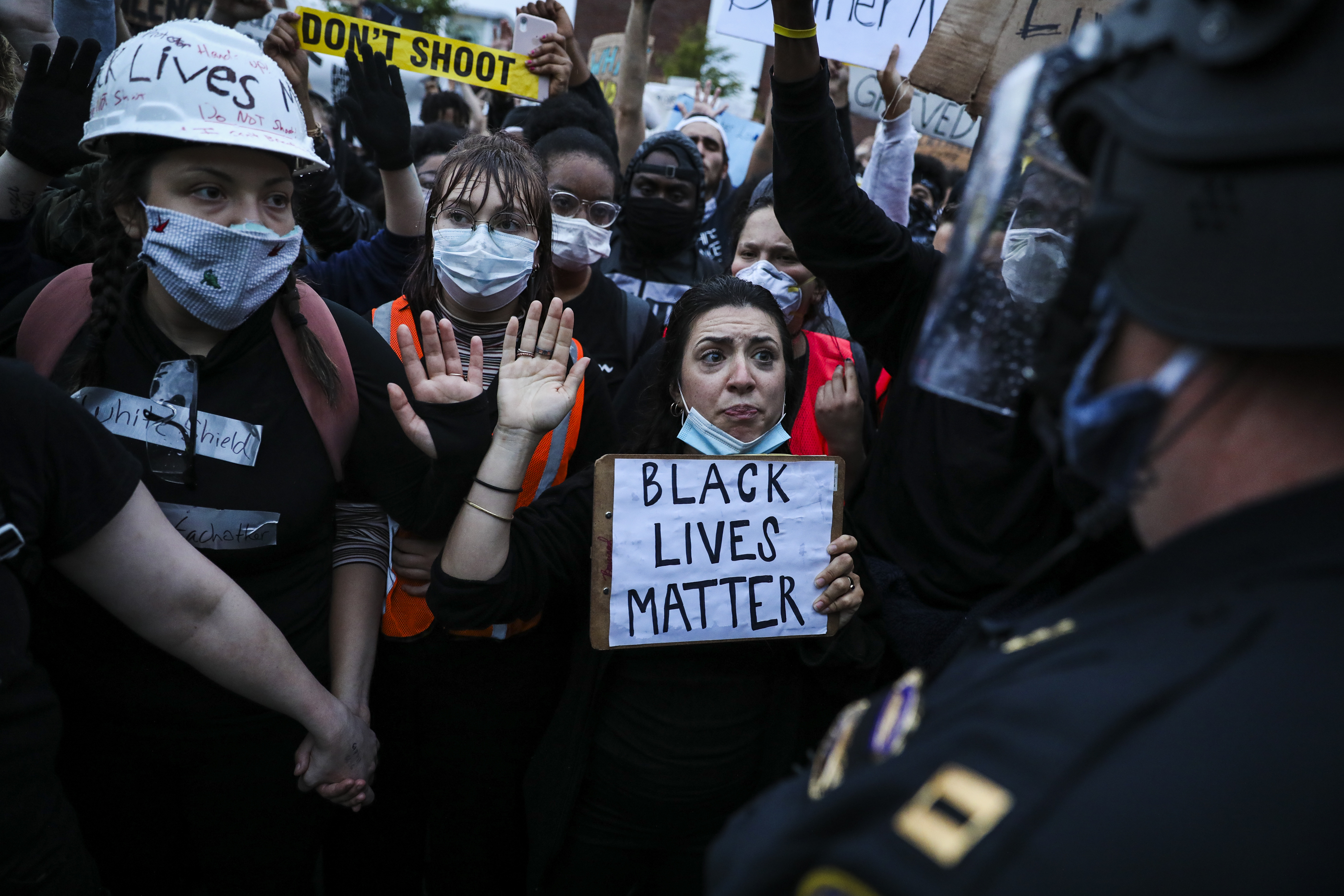 Activists pleaded with the Boston Police to "take a knee" as they participate in a demonstration outside of the Forest Hills T Station.