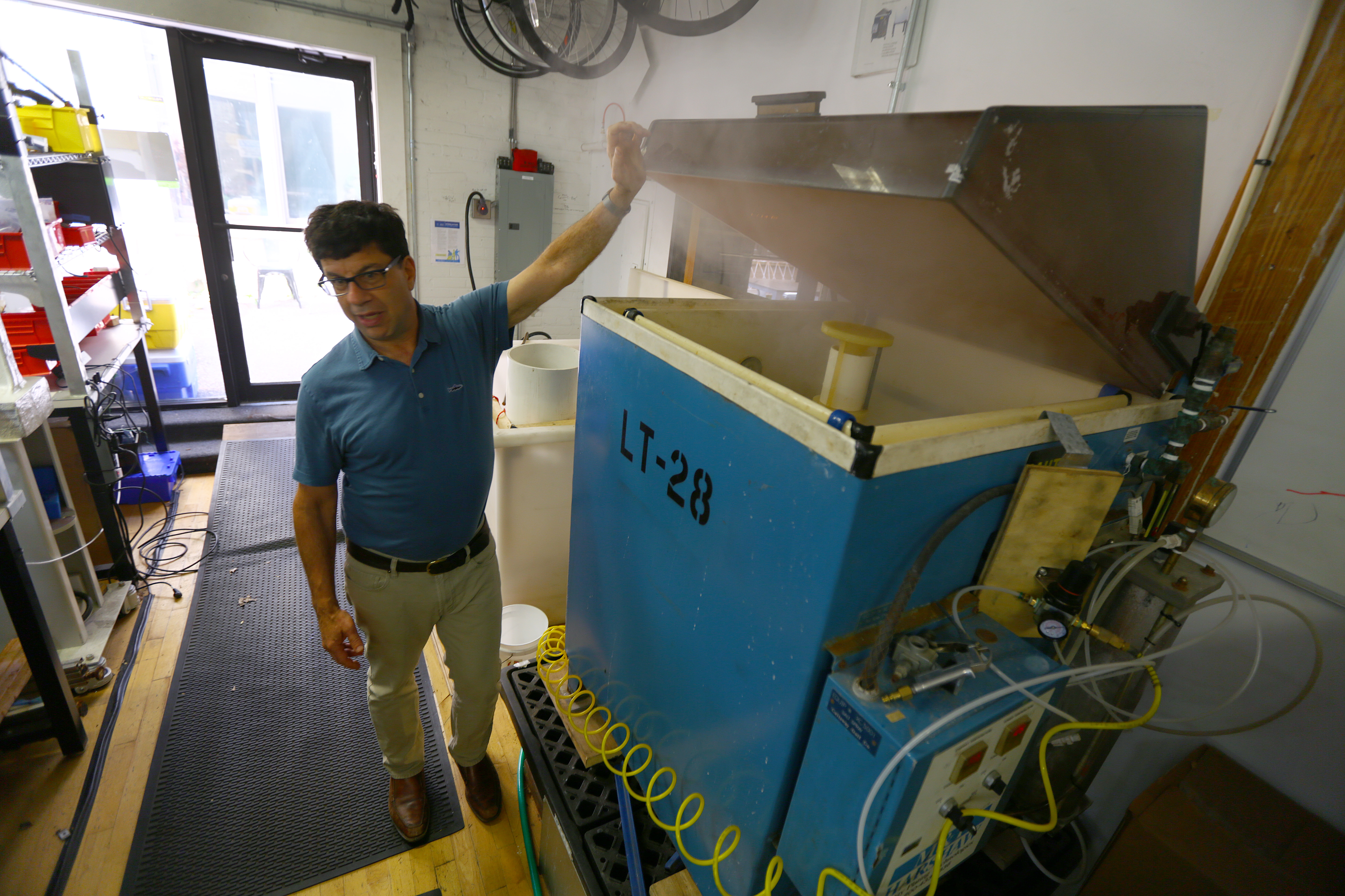 David Michael, director of mechanical engineering at Superpedestrian, stood next to a salt fog machine, which conducts accelerated salt corrosion tests.