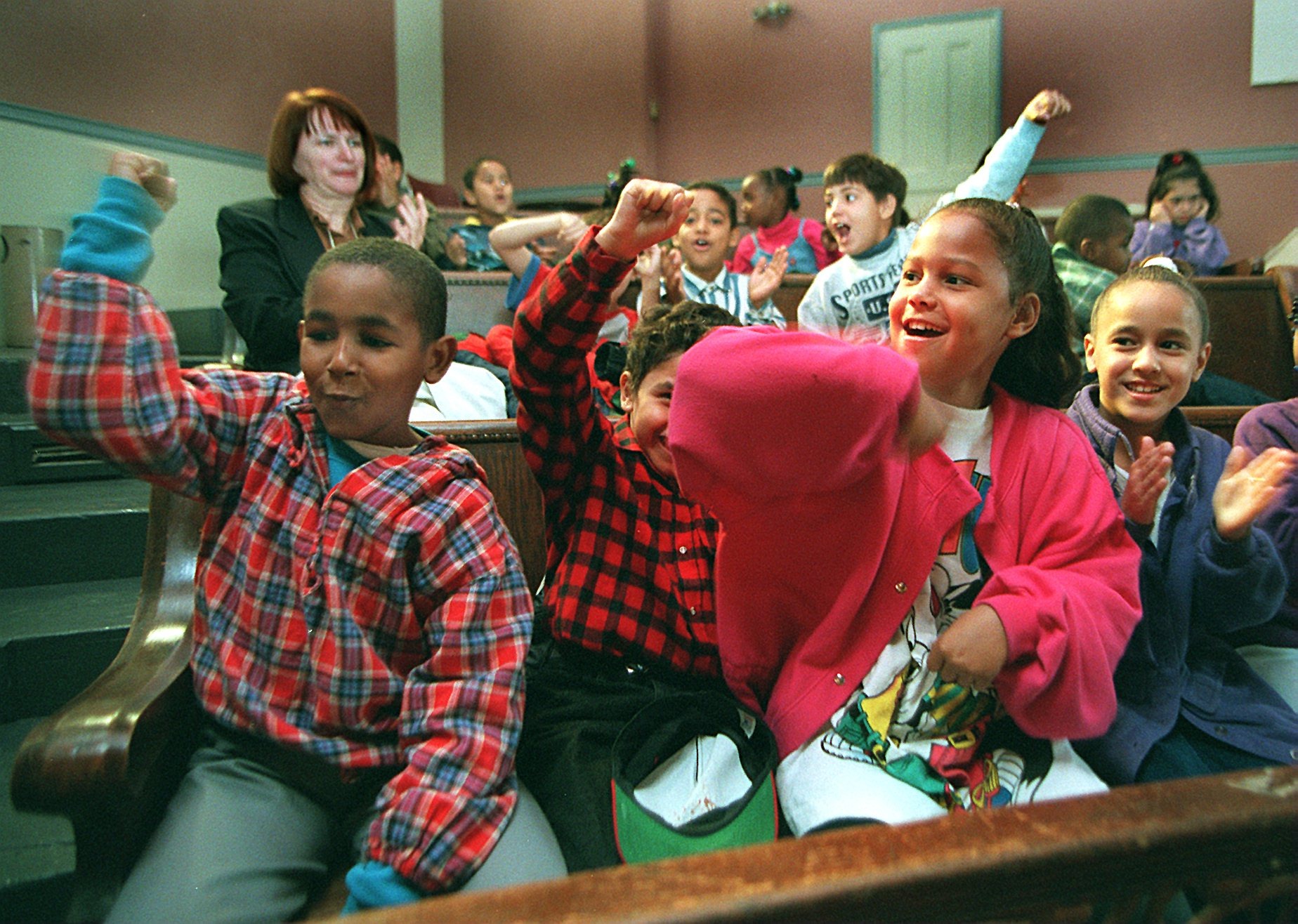 Third graders from the Hurley School in the South End cheered during a musical performance by Pedro Guzman at the Villa Victoria Center for the Arts on Oct. 27, 1995.