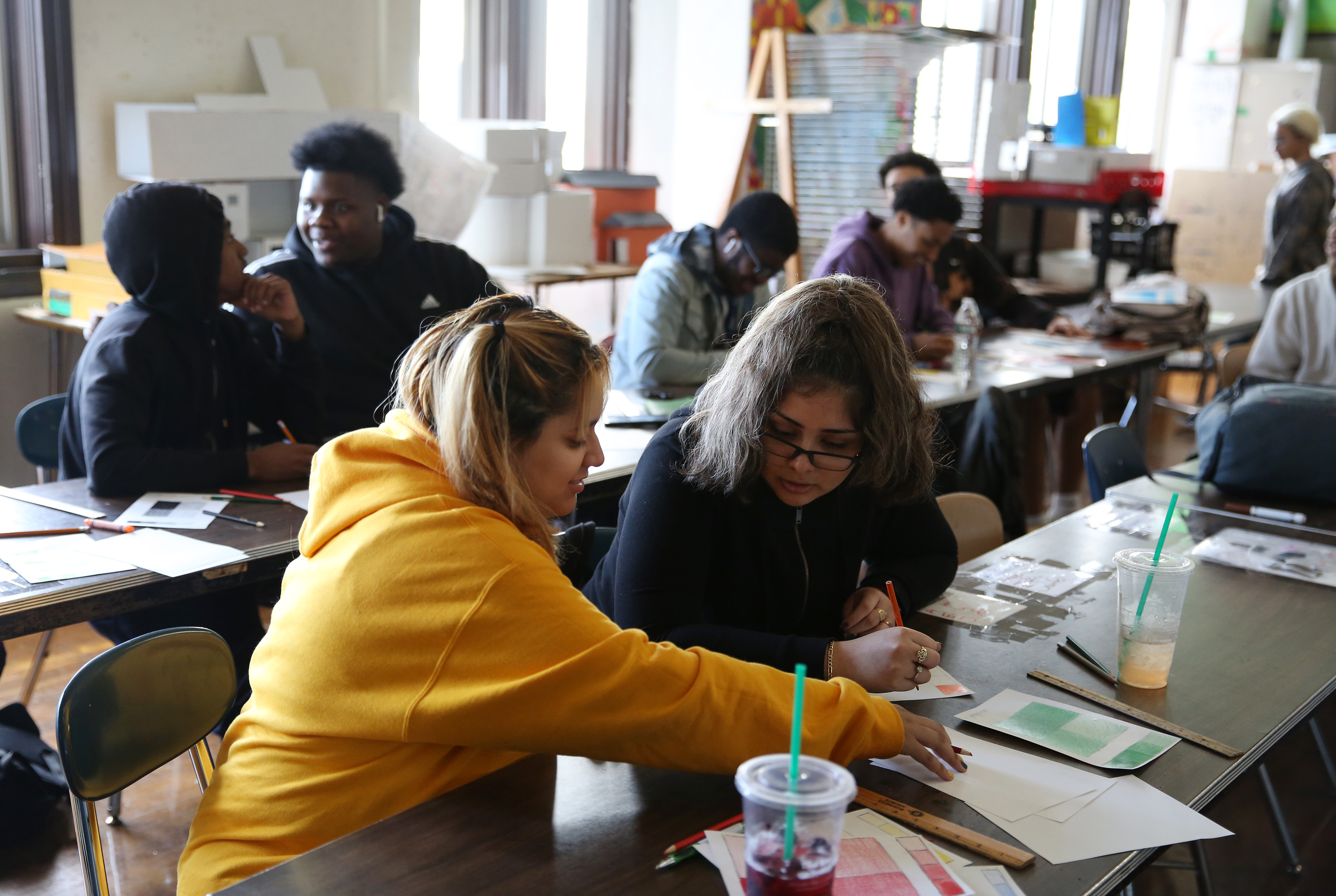 Britney Mendez (left) chatted with her best friend, Emily Alvarado, during AP Art at Brighton High School. The pair met during freshman year, when they bonded over their shared history.