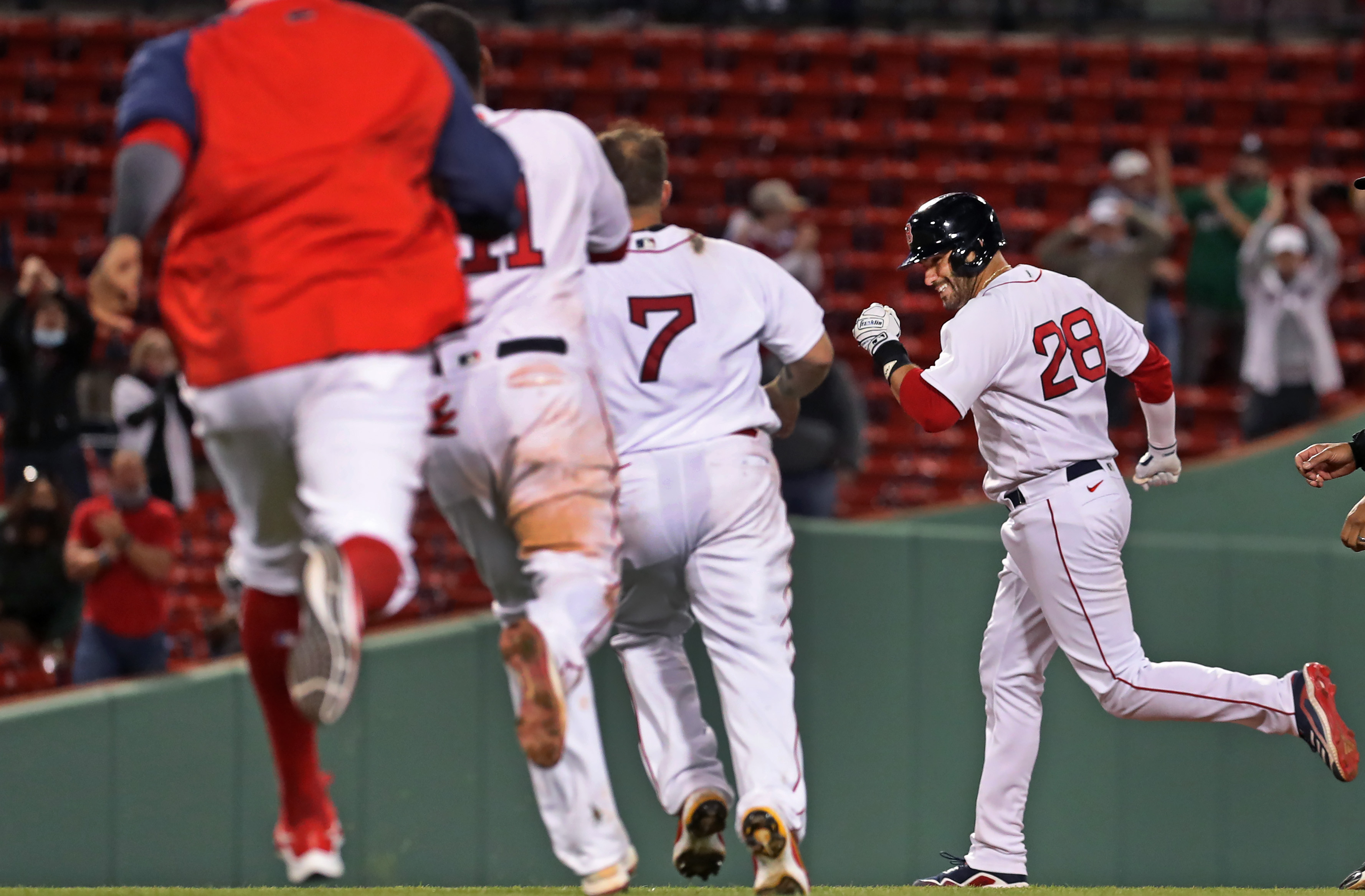 J.D. Martinez is chased by teammates after his game-winning hit Tuesday night.