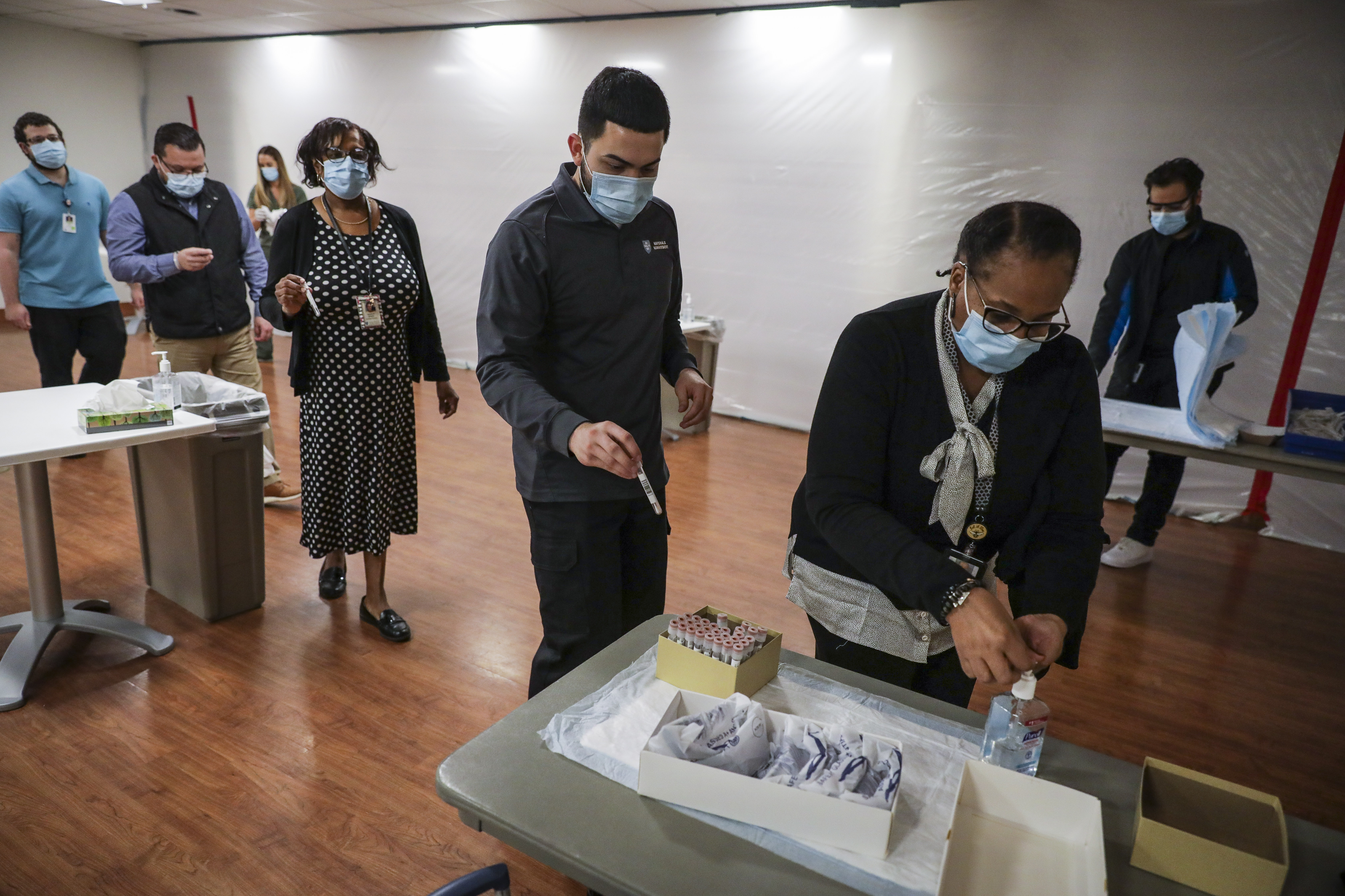 Hospital workers finished performing a self-administered COVID-19 test at Massachusetts General Hospital on Thursday. As cases rise all across the country, hospitals are ramping up their facilities to prepare for incoming patients.