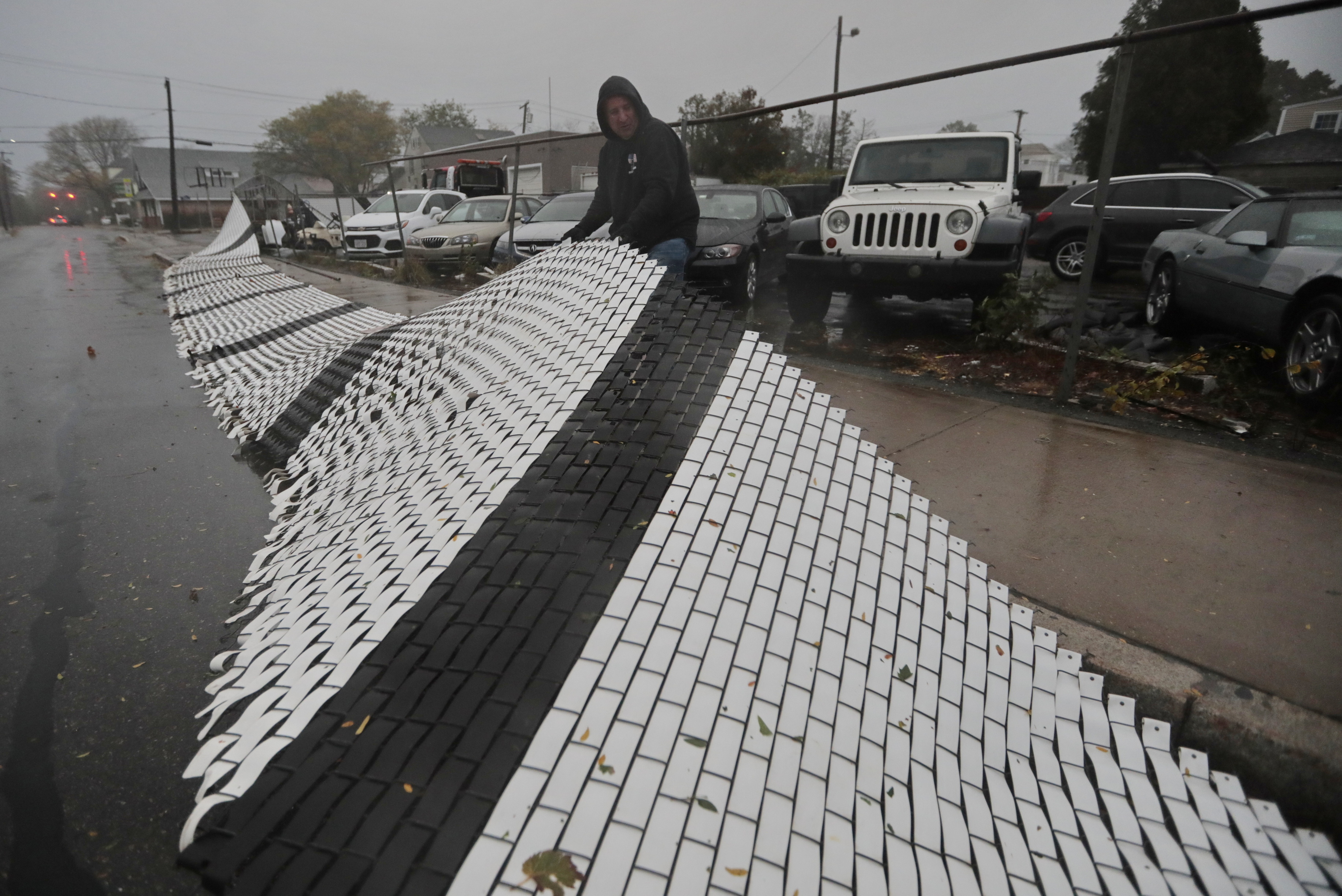 Gillie Rezendes of Artistic Autobody pulled the fence that was blown onto Middle Street in Fairhaven.