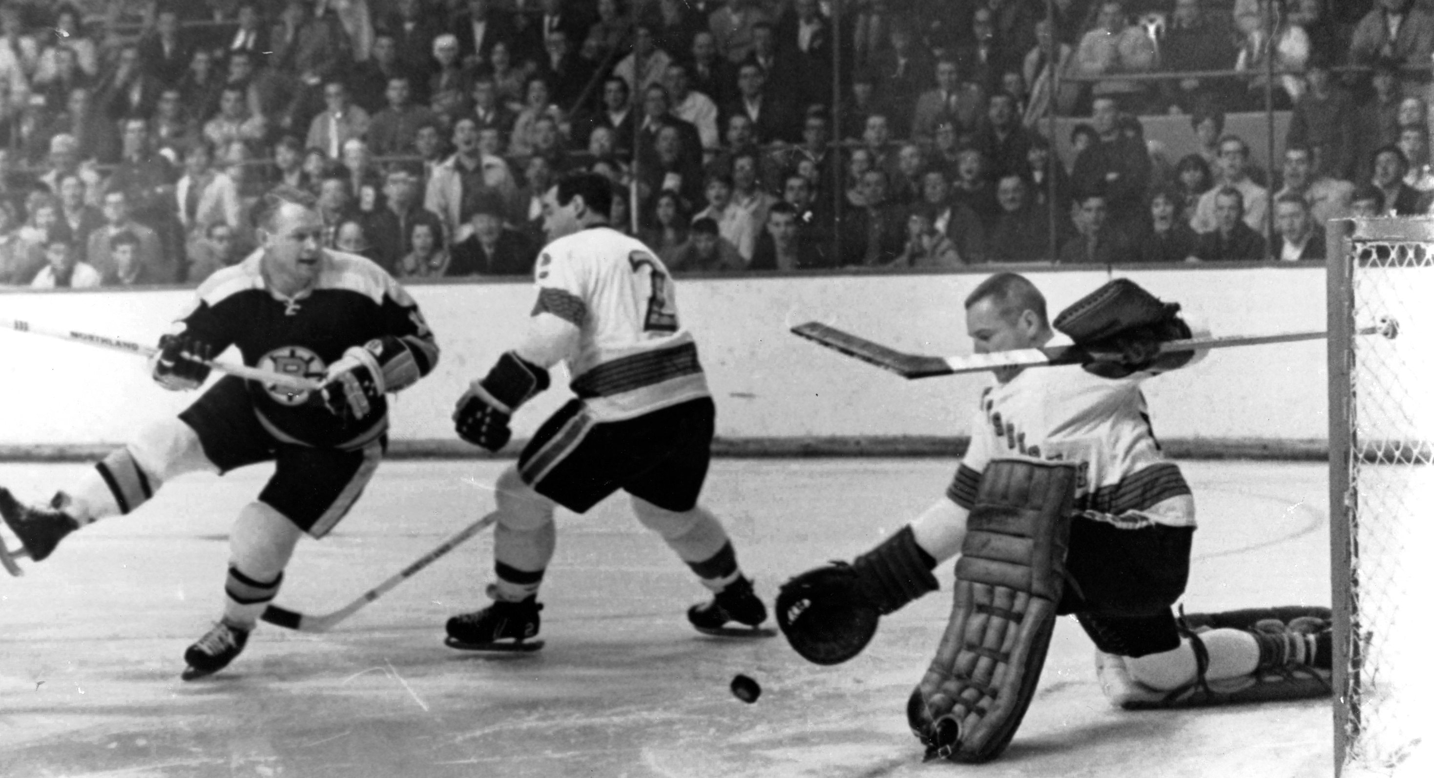 Leo Boivin, center, playing for the Penguins, defends against Bruins forward John McKenzie (left) in Oct., 1967. Boiwin played 12 seasons with the Bruins from 1954-66.
