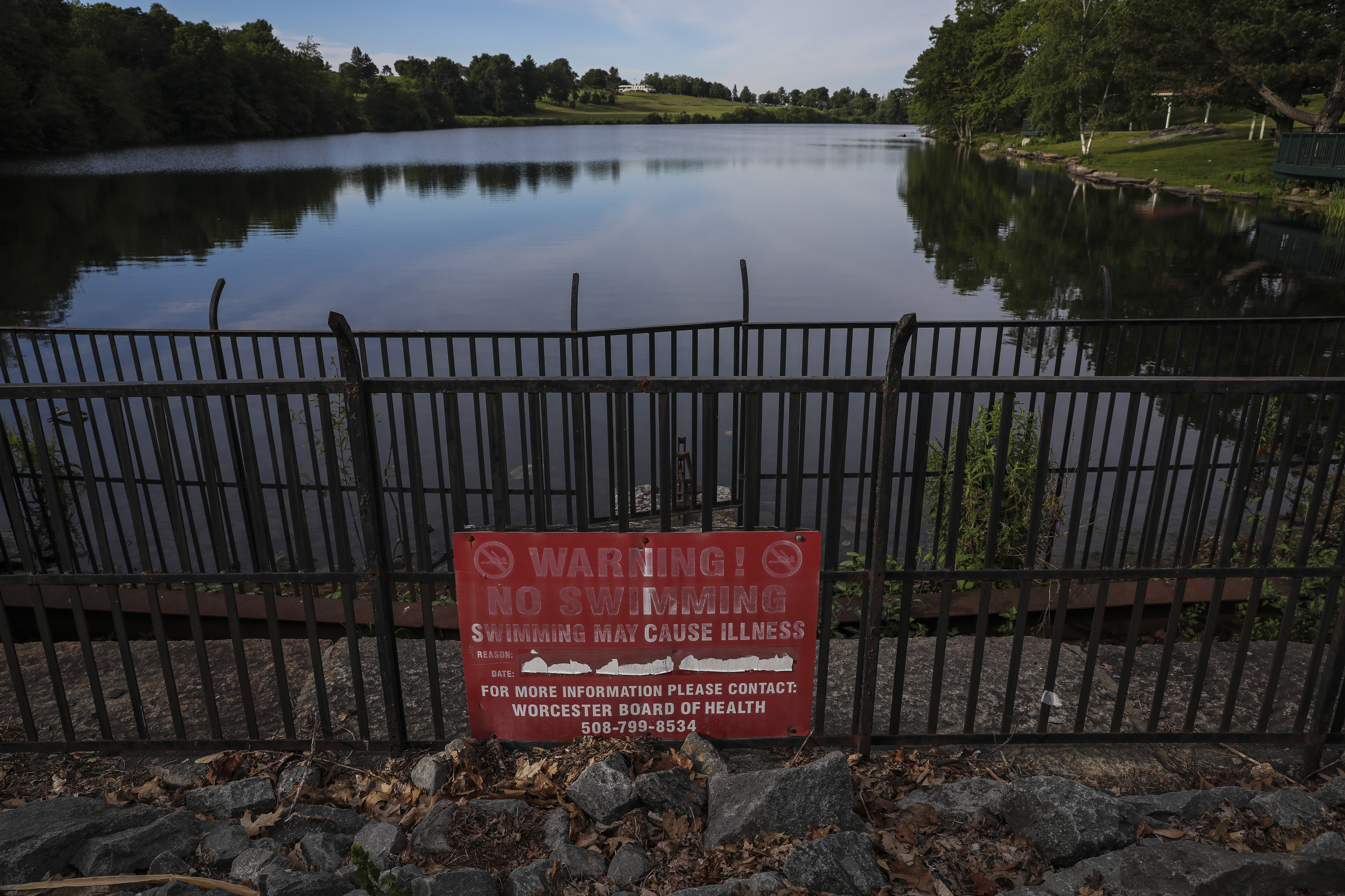 A "No Swimming" sign is seen at Green Hill Pond on Friday.