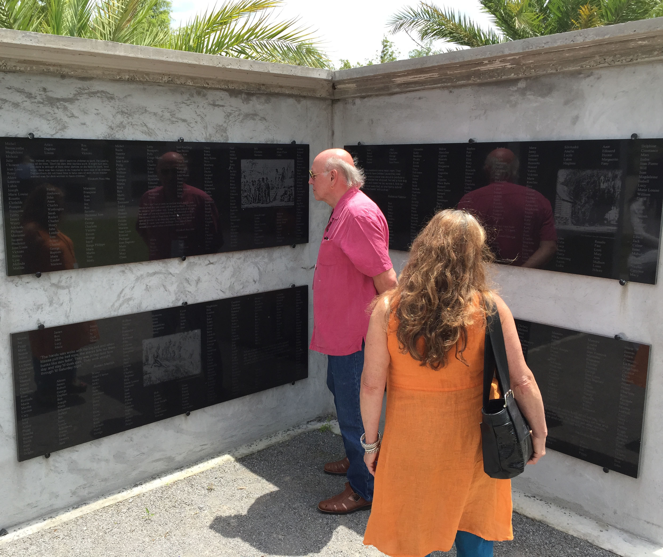 Jim Smith and Paula Barry of Conway, Mass., examined names of Louisiana slaves recorded on the 18 monument walls in the Allées Gwendolyn Midlo Hall at Whitney Plantation.