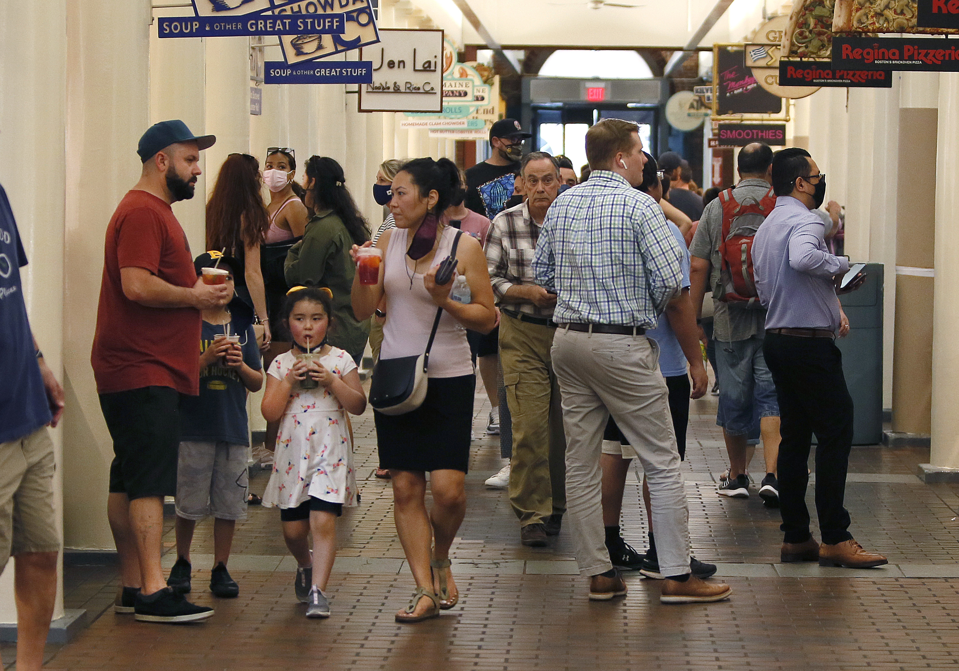 Quincy Market in the Faneuil Hall Marketplace is filled with visitors seeking food and drinks.