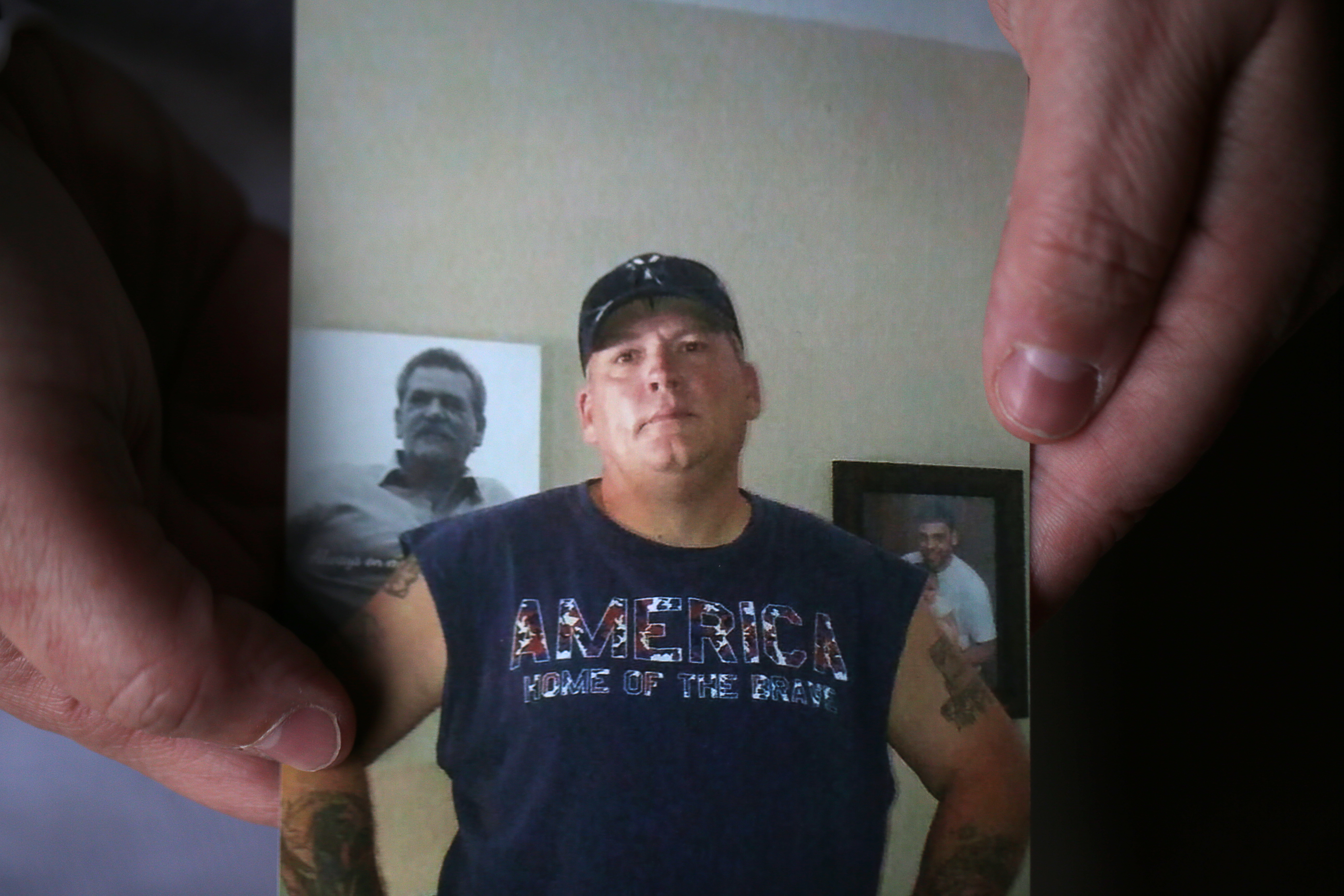 Tammy Roberts held a photo of her husband, Michael, who is one of the missing crewmembers.