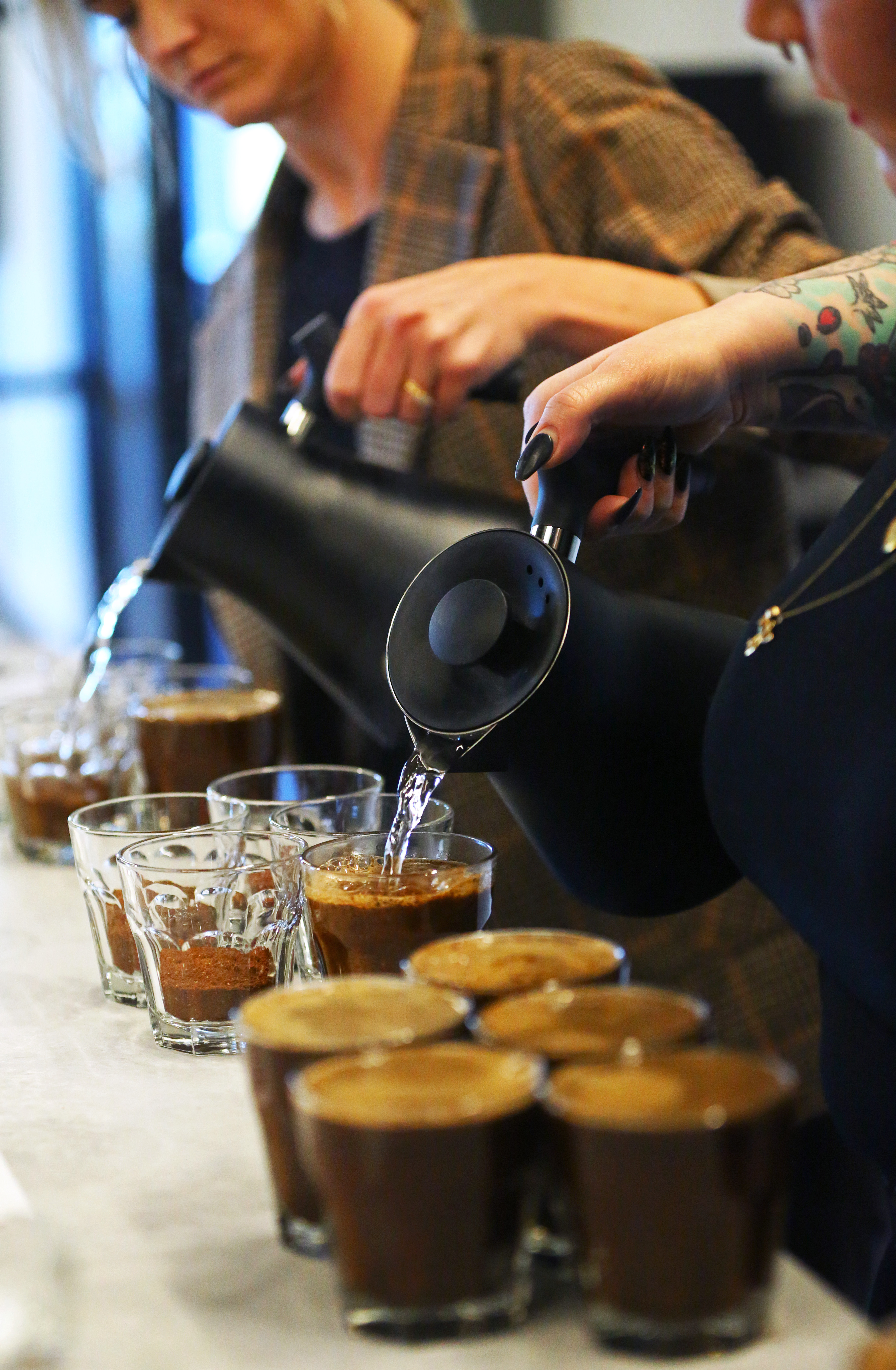 Carly Getz (left), coffee education manager, and Rachel Apple, quality and qualifications manager, prepared coffee samples.