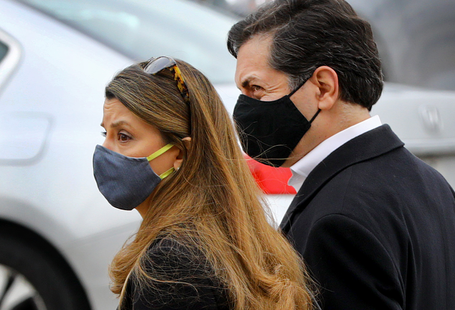 Iman Ali Pahlavi, left, and her husband Bahram Pahlavi leave the courthouse after a judge's ruling against their neighbor, Dr. Richard Gordon.