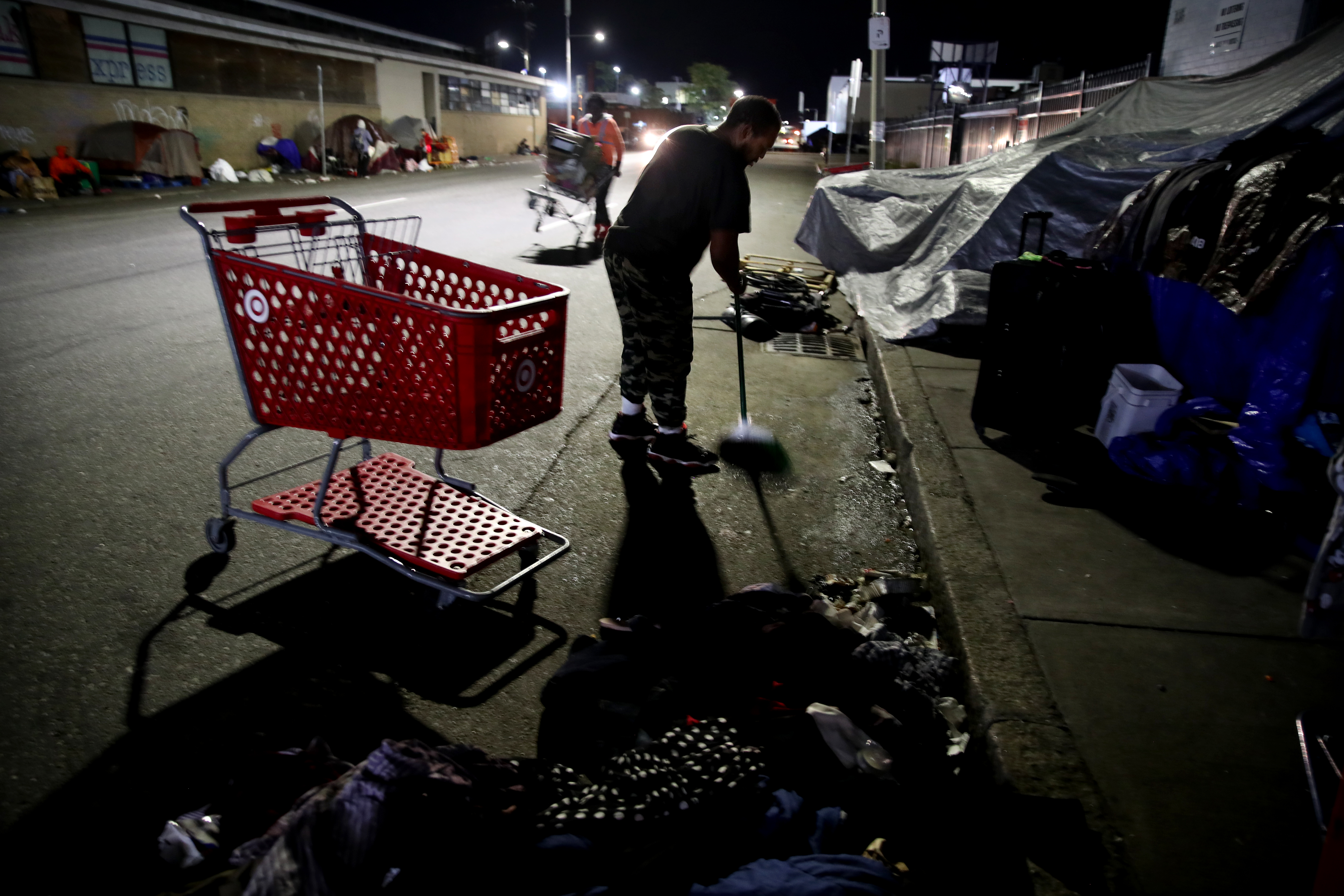 Rico swept the street outside his tent on Southampton Street.