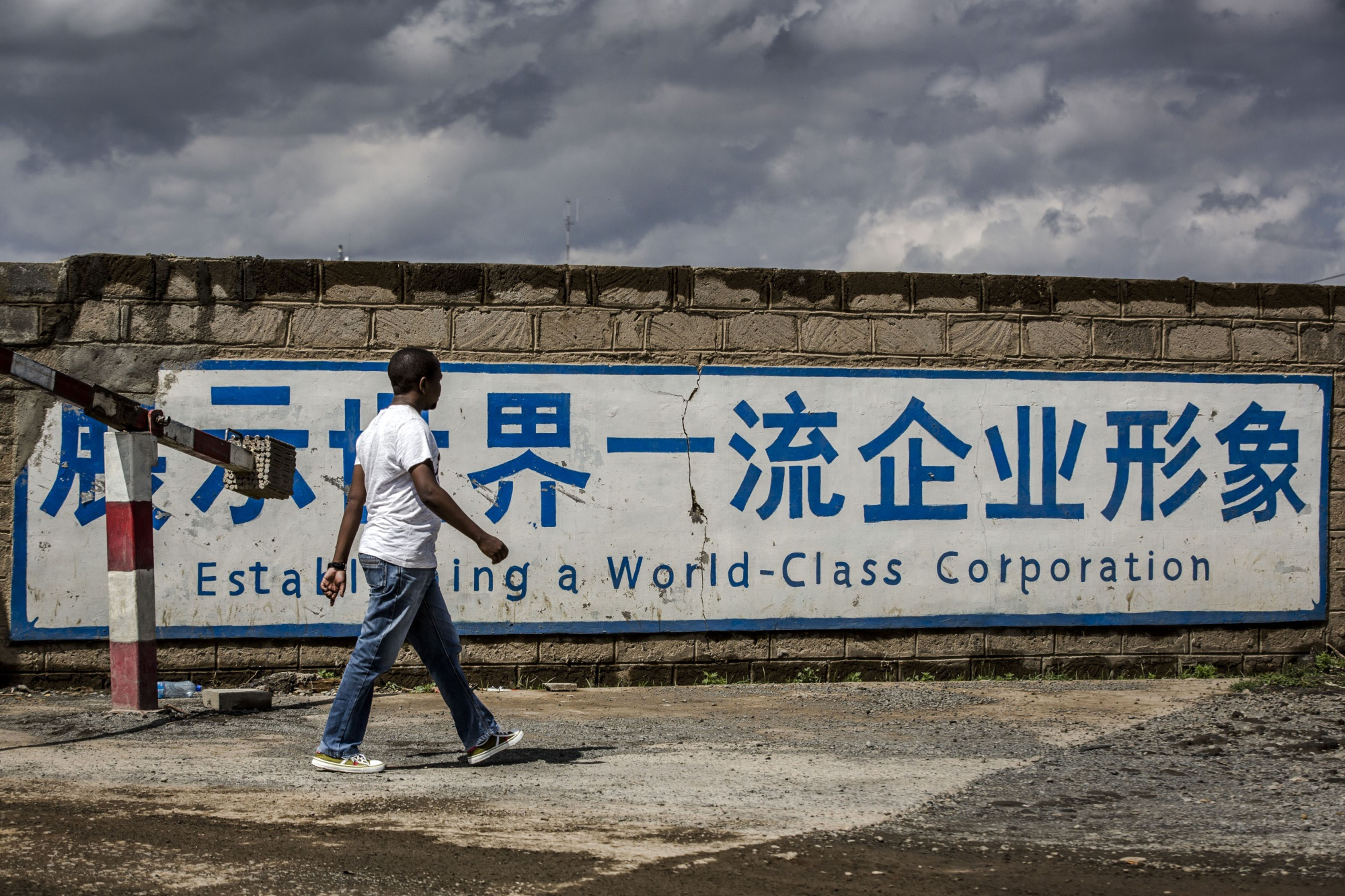 A pedestrian walked past a sign for China Communications Construction Co. outside the headquarters of a project in Maai Mahiu, Kenya.