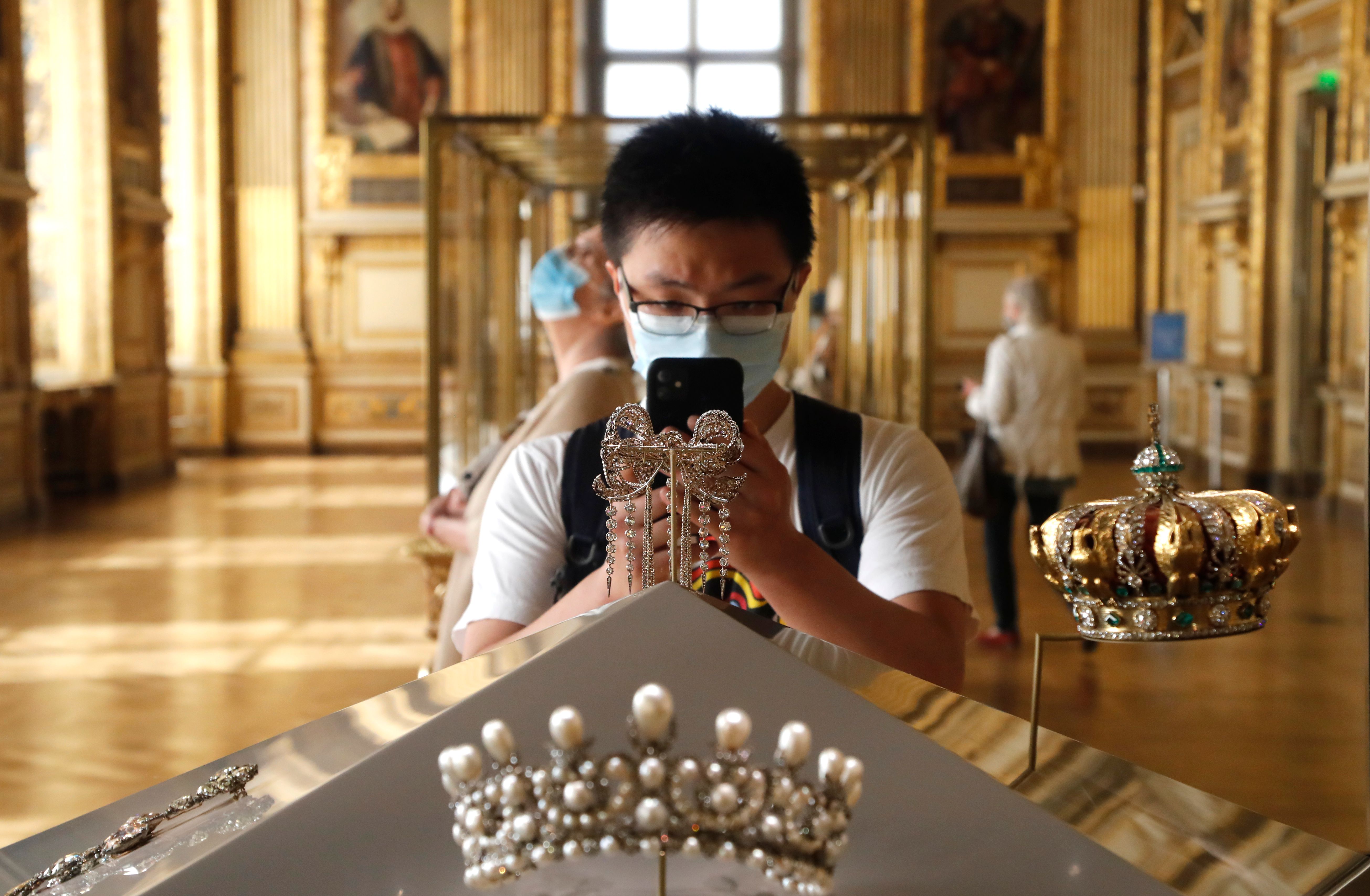 A visitor took a picture of the Empress Eugenies jewelry piece held at the Apollo gallery at the Louvre Museum in Paris.