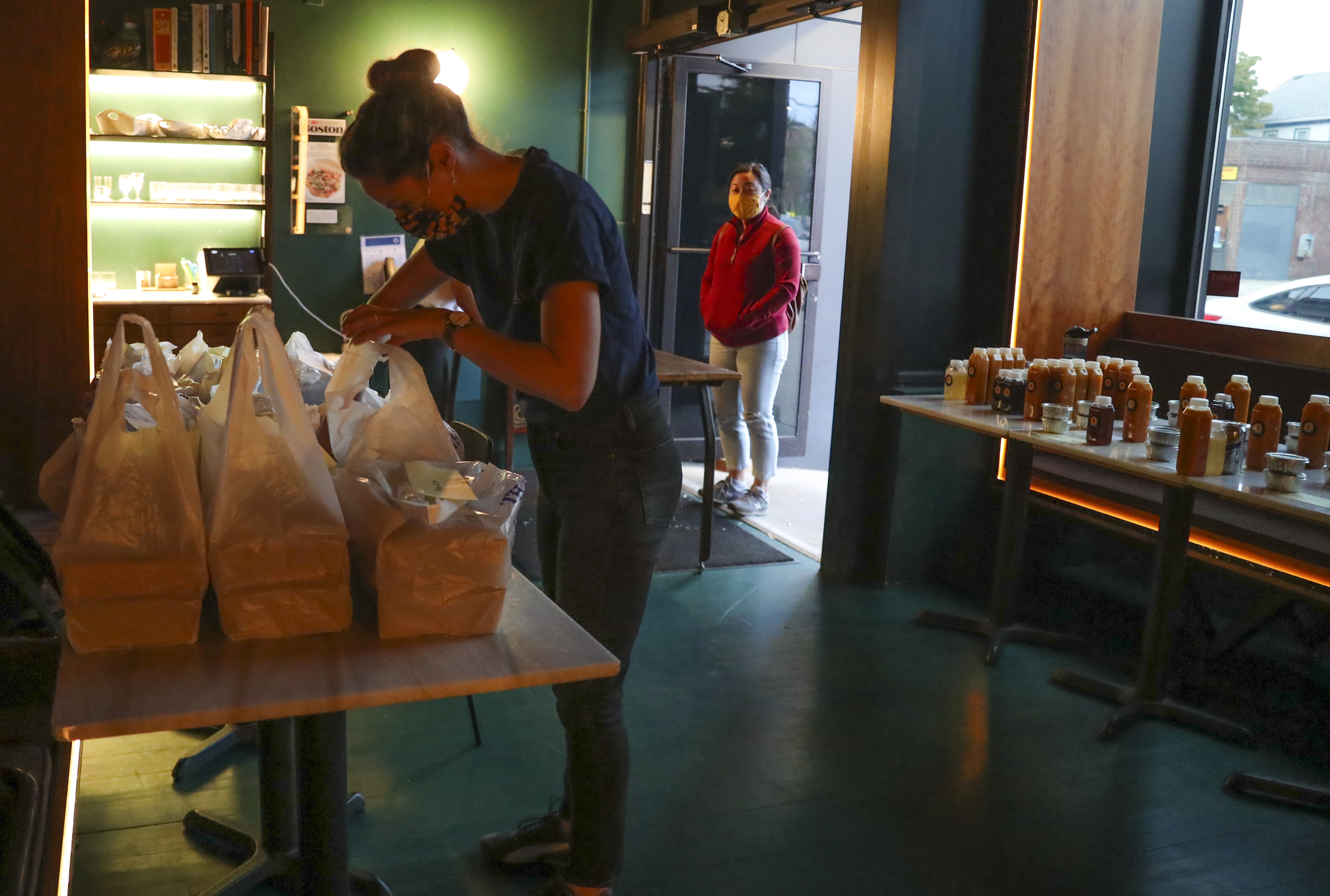 Kate Hardy gets a customer’s dinner order ready for pick up at the Sekali pop-up to go at the Fat Hen.