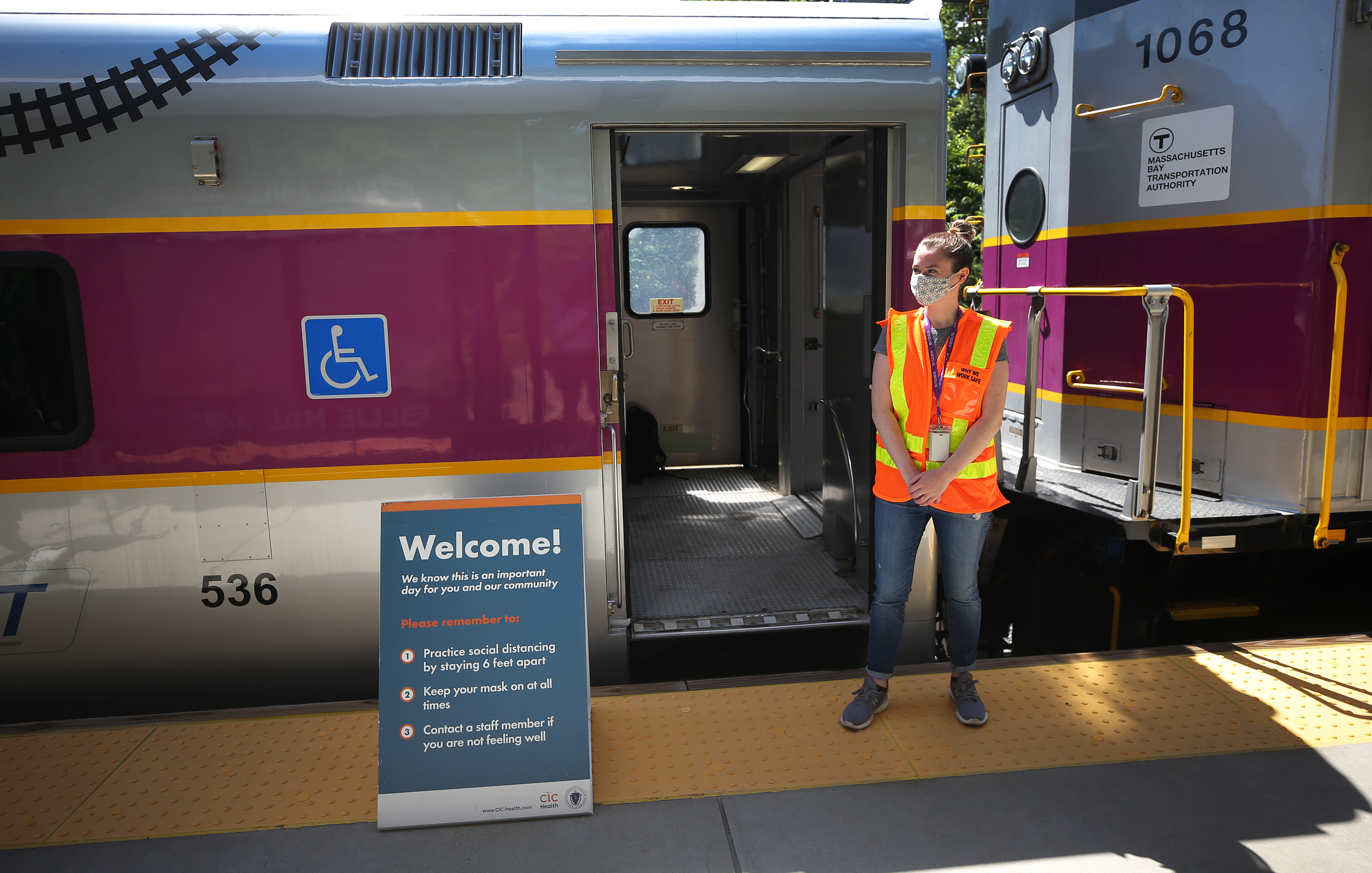 Kerin McManus, a Keolis employee, greeted those who wanted to receive a COVID-19 vaccine by the train entrance.
