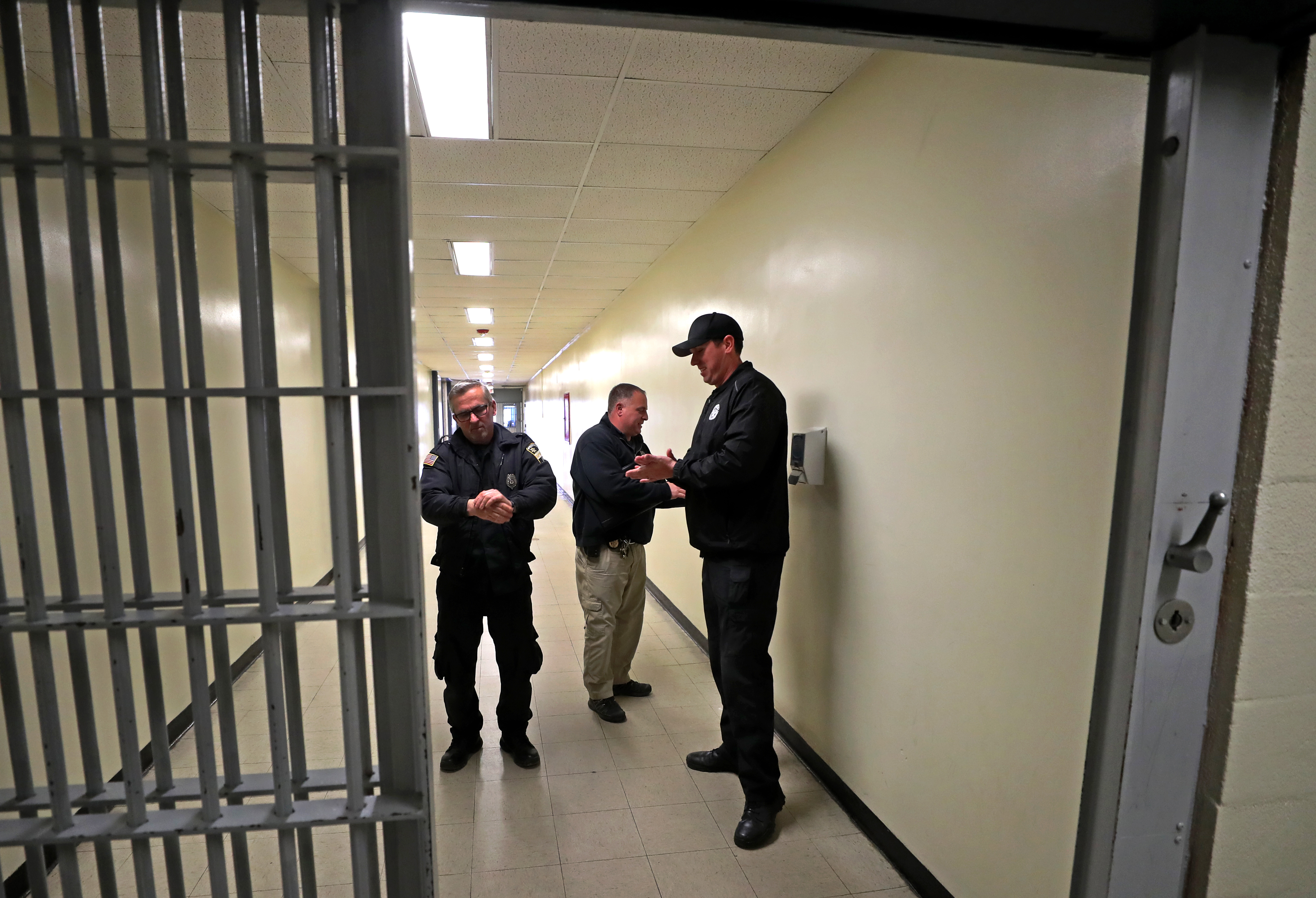 WEST BOYLSTON, MA - 4/01/2020: Correctional officers using alcohol hand sanitizer before entering the main cell block area. At the Worcester County House Of Corrections in West Boylston during the COVID-19 coronavirus pandemic inmates and correctional officers taking measures fighting against the virus.  (David L Ryan/Globe Staff )