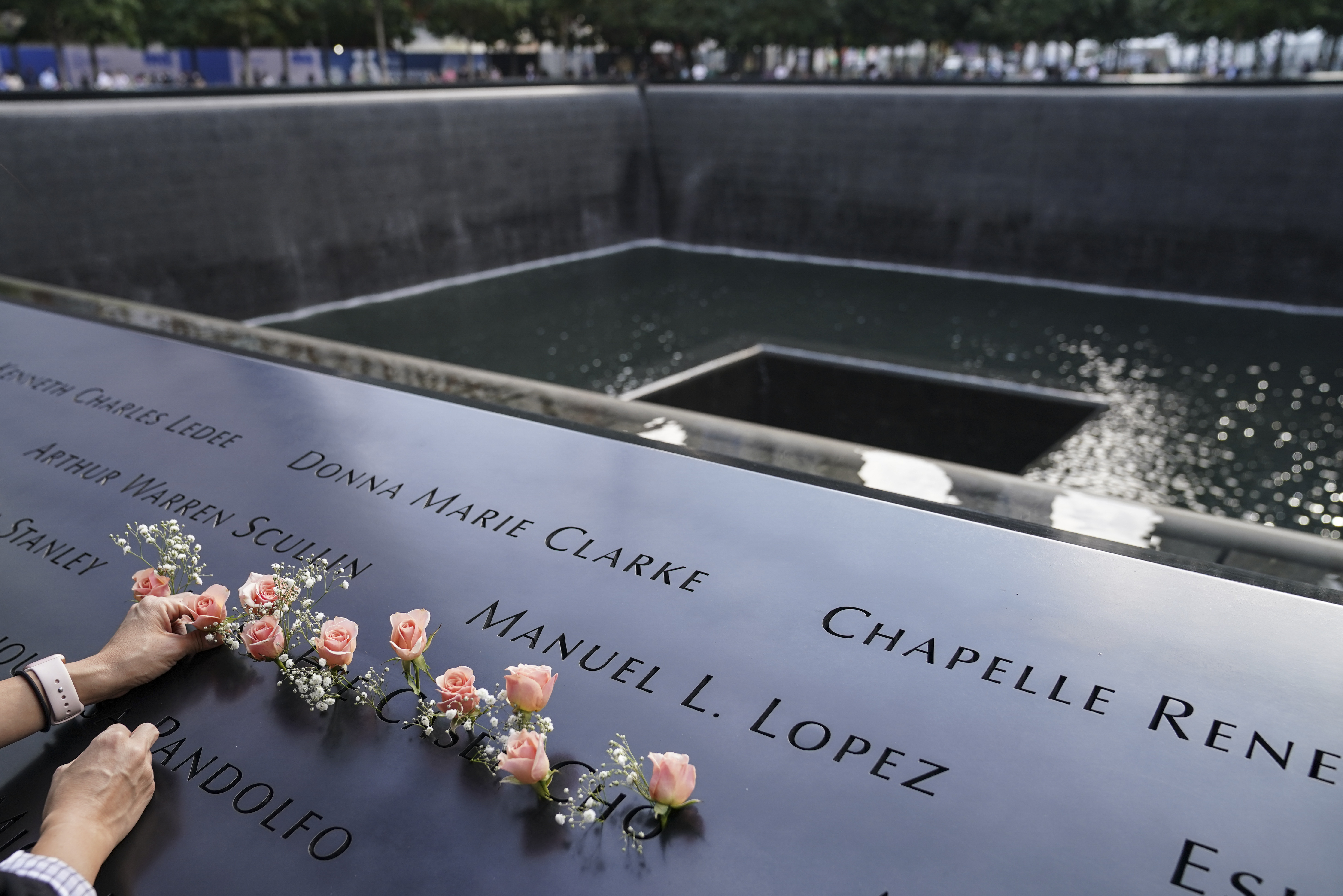 Mourners place flowers in the name cut-out of Kyung Hee (Casey) Cho at the National September 11 Memorial and Museum in New York.