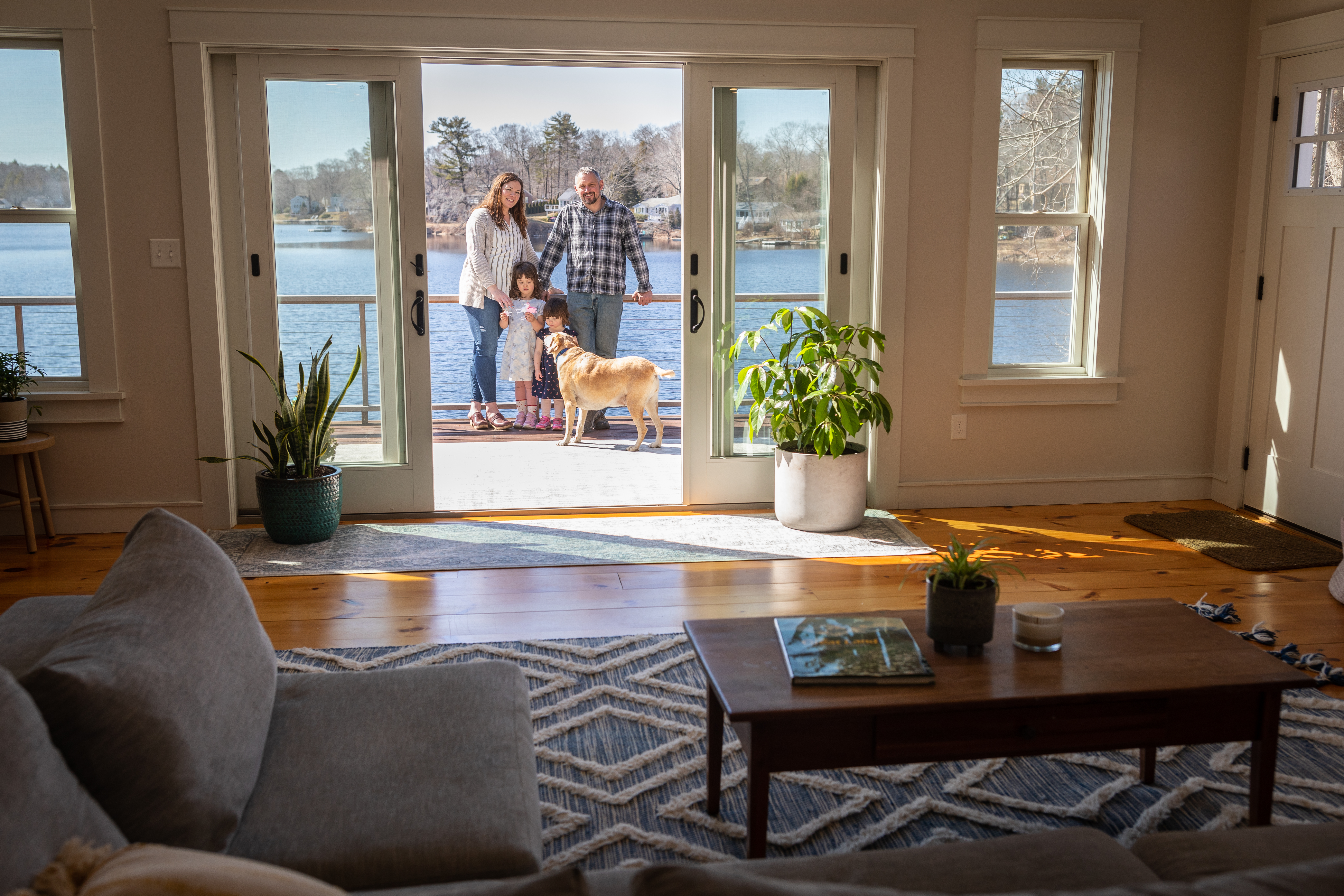 Mike and Emily Broderick with their daughters, Rowan and Cora, on a deck they built at their home in Essex.