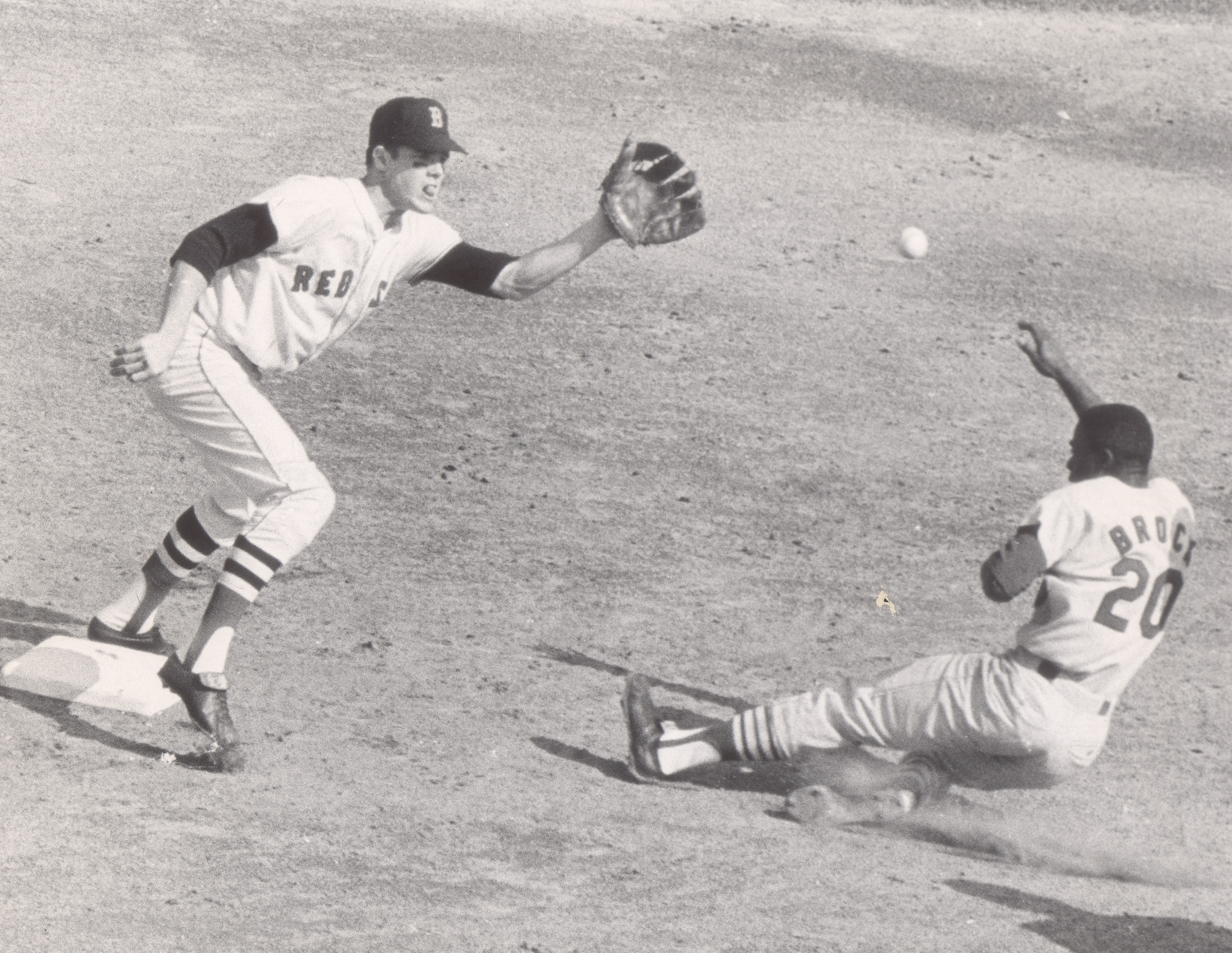 Lou Brock steals second against the Red Sox in the 1967 World Series, with Mike Andrews taking the throw.