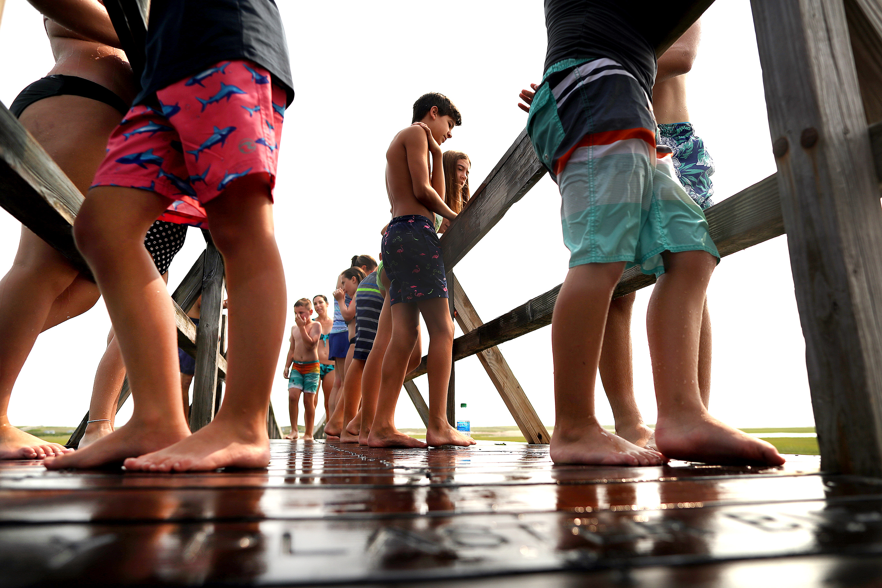 Youngsters waited to jump from the Sandwich boardwalk into the water.