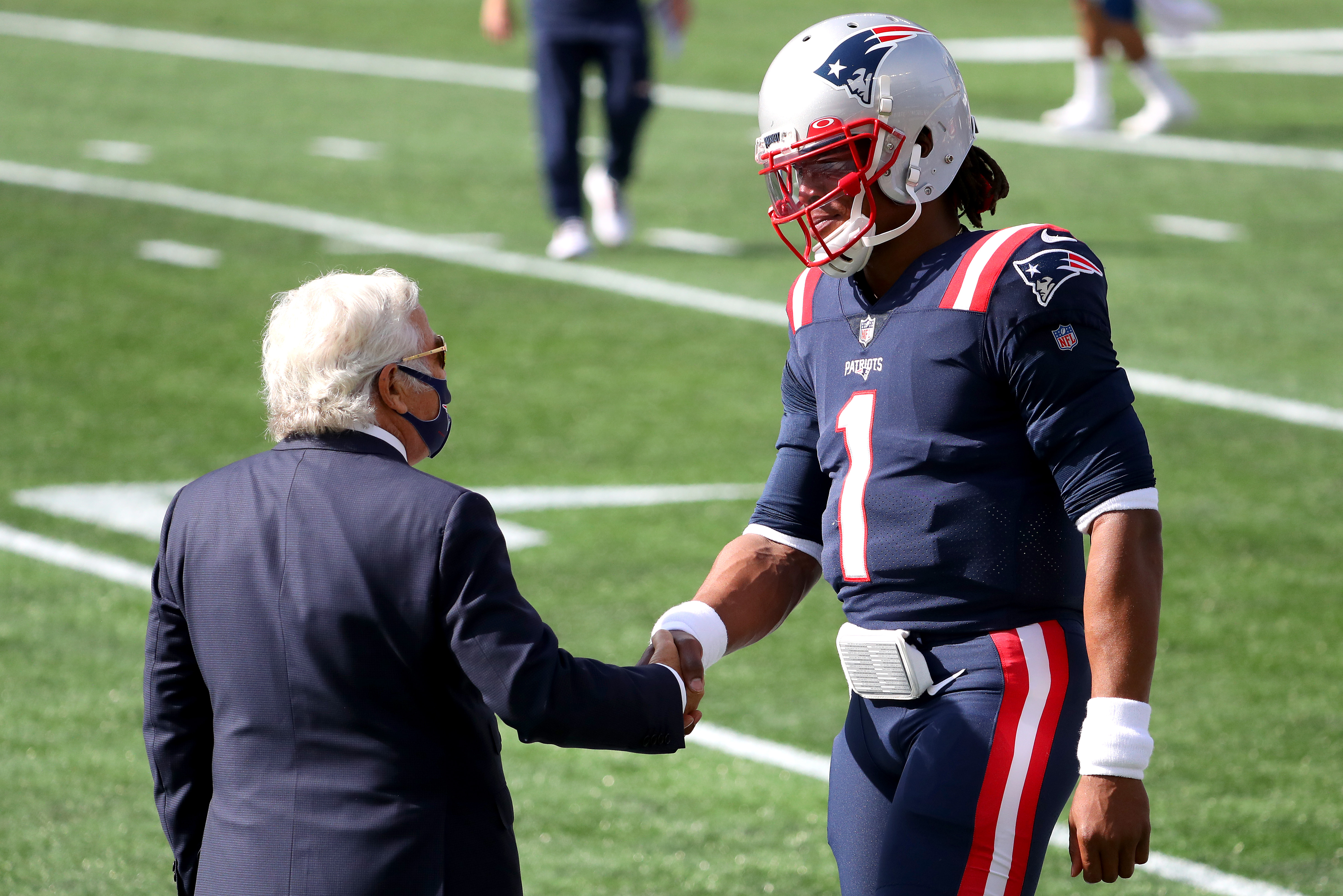 Robert Kraft and Cam Newton shake hands prior to a game against the Broncos last October.