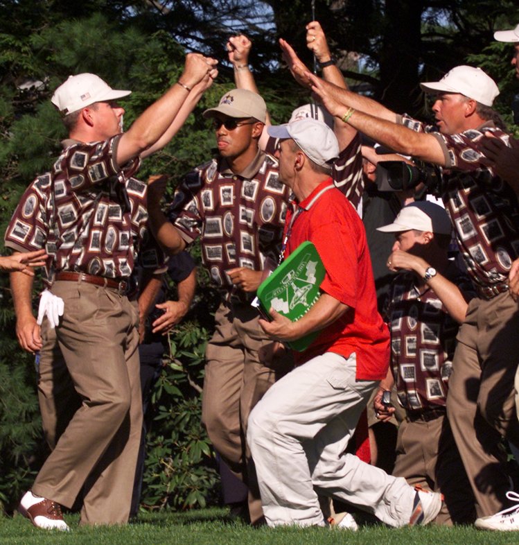 Justin Leonard (left), celebrates with Tiger Woods (with sunglasses), and Tom Lehman (far right) and other teammates on the 17th green after the American team won the Ryder Cup in 1999.