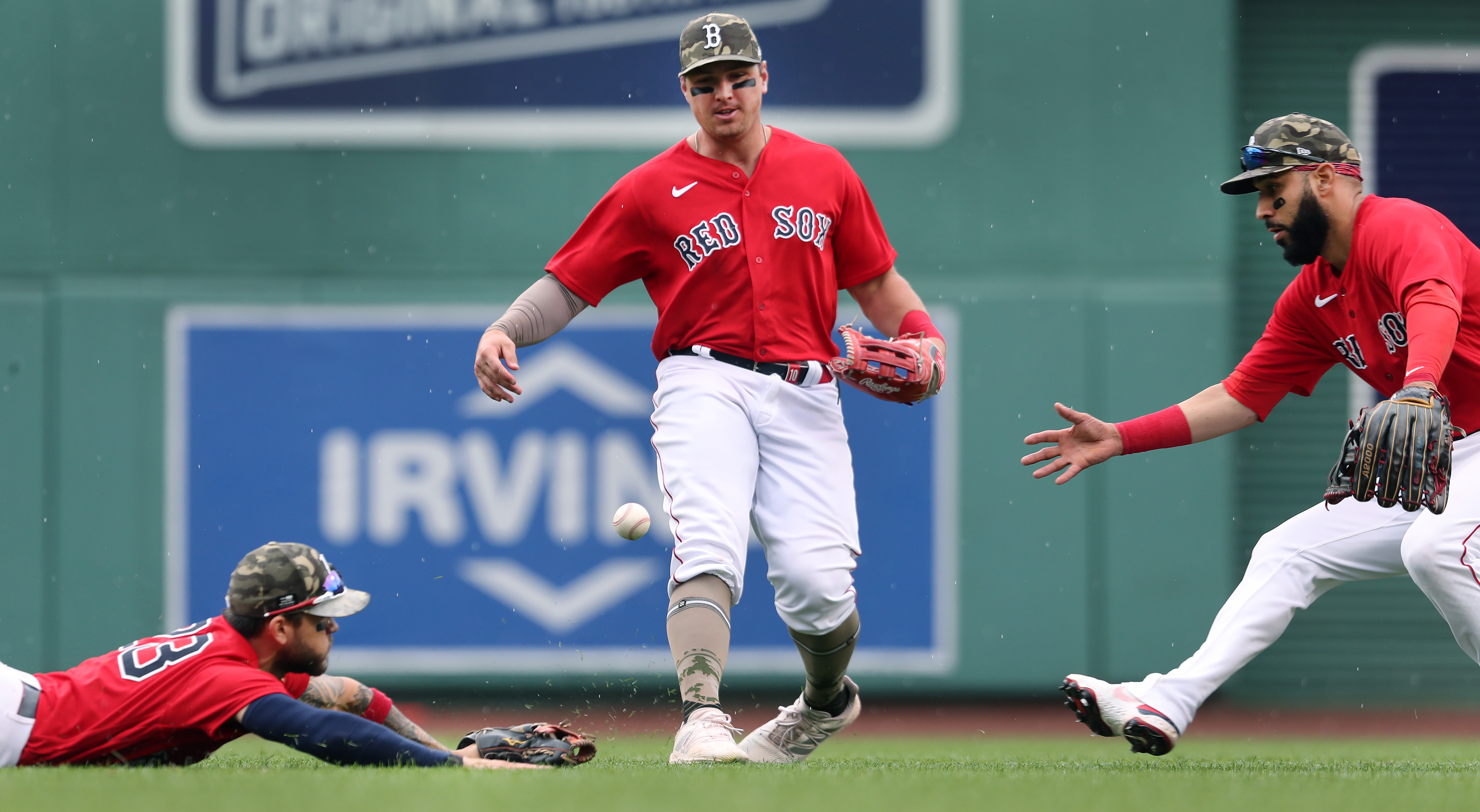 Michael Chavis, left, Hunter Renfroe, center, and Marwin Gonzalez all tried but couldn't come up with this key bloop off the bat of Mike Trout late in Sunday's loss.