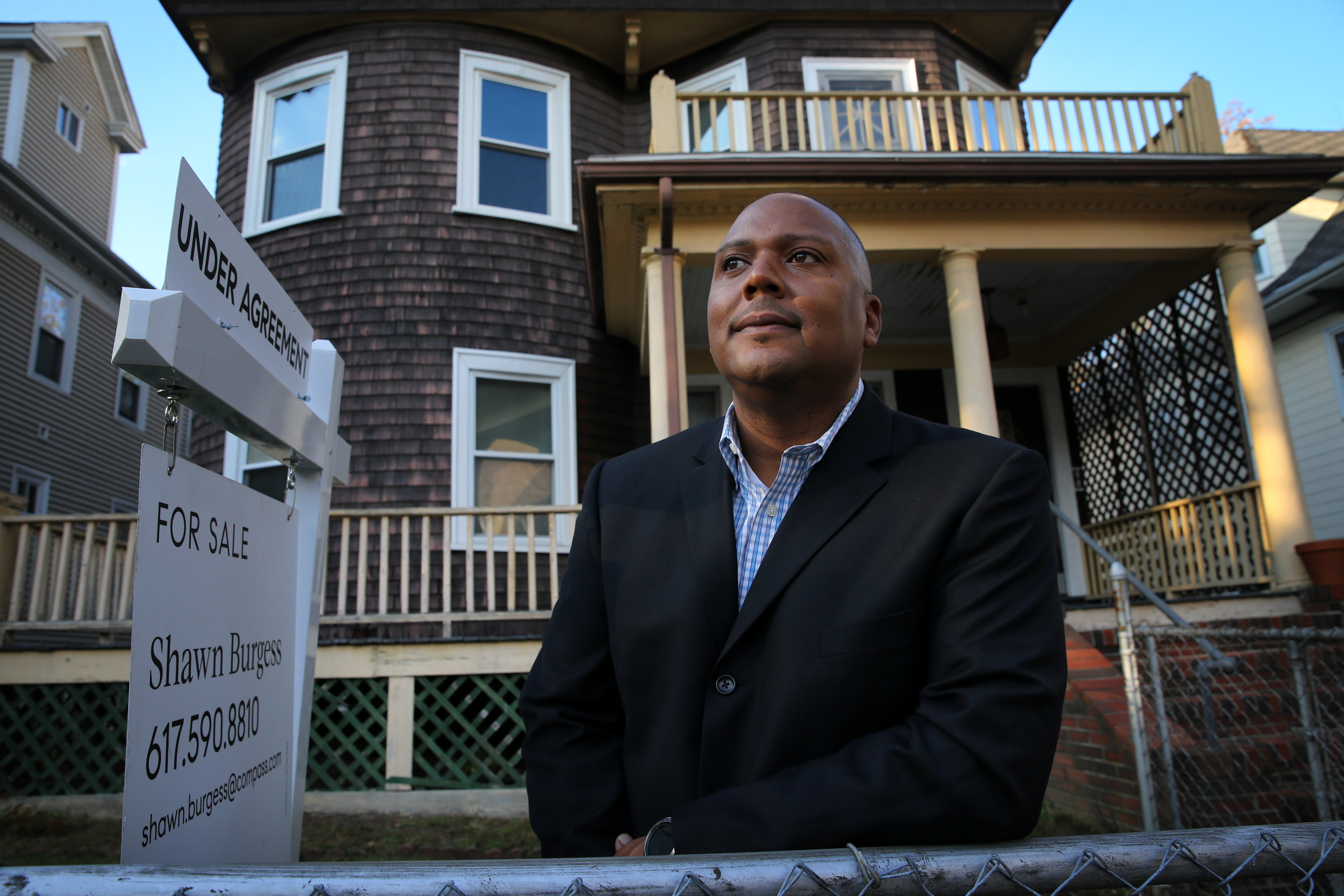 Shawn Burgess poses at a home he is marketing in Dorchester on Oct. 22.