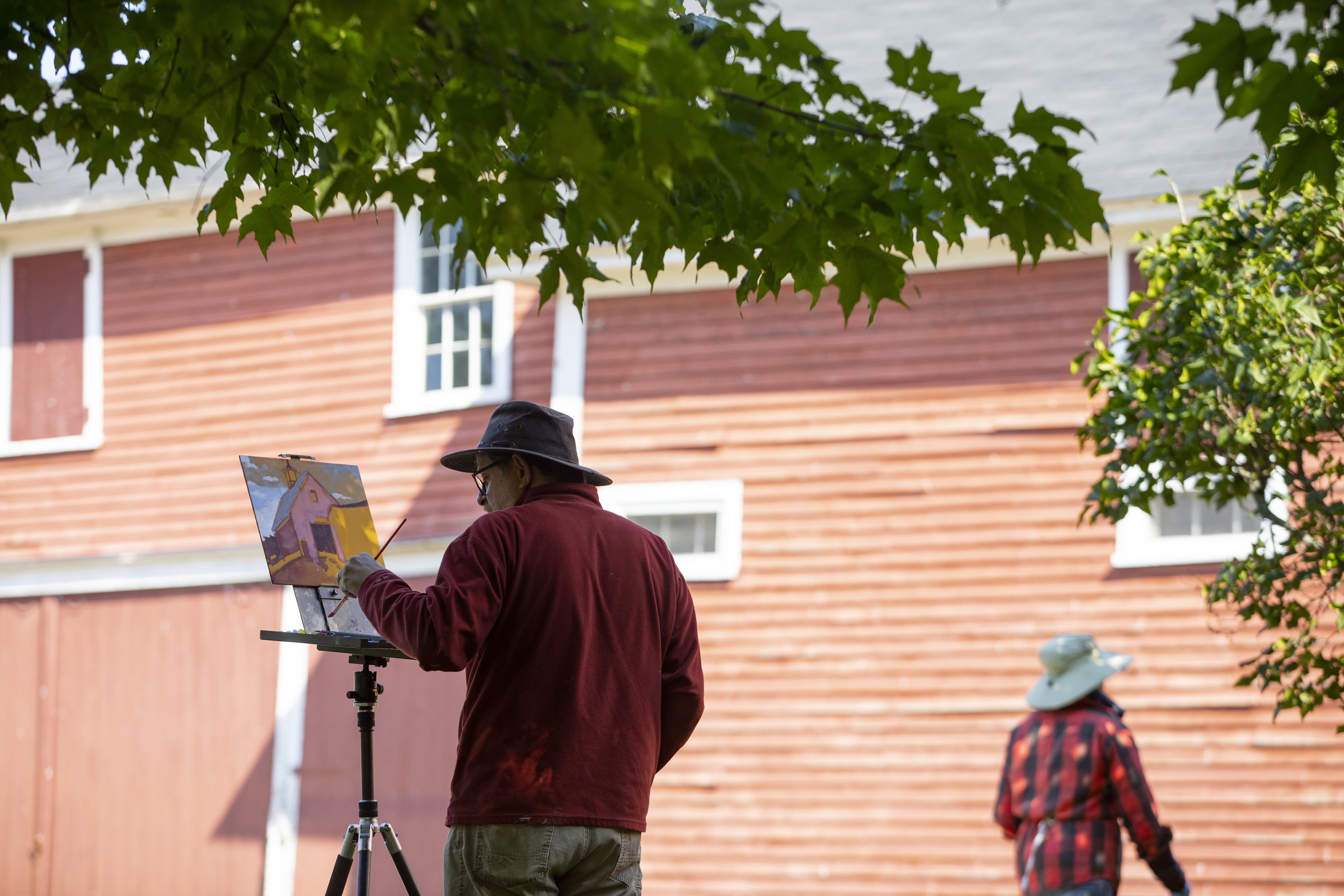Jeff Pacione of Wenham paints during an outdoor painting class at Cogswell's Grant in Essex.