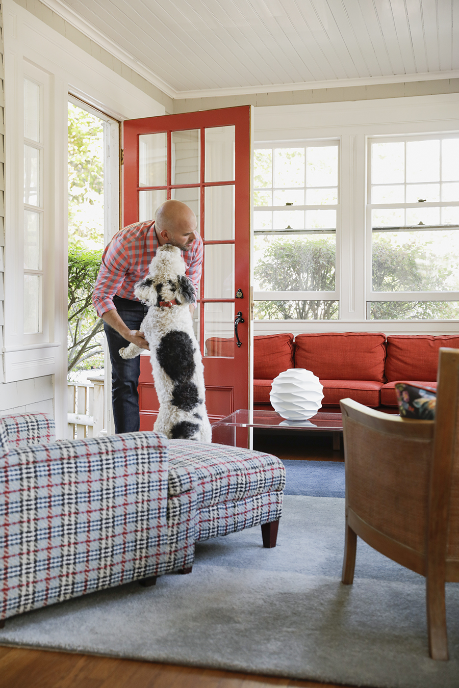 Homeowner David Duncan Morris greeted by Sylvester at the porch door.