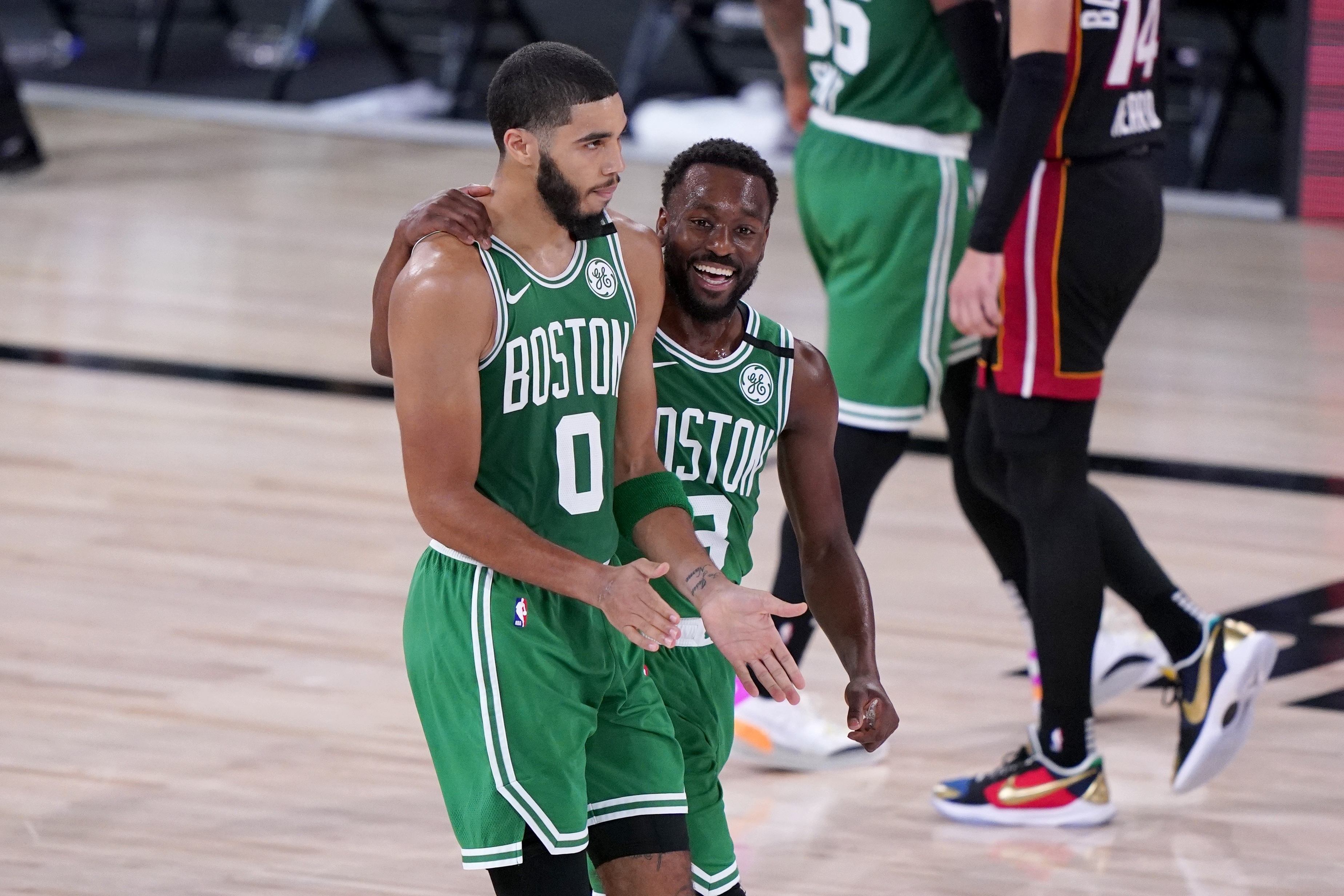 Jayson Tatum and Kemba Walker walk off the floor at the end of the first half of Saturday's game.