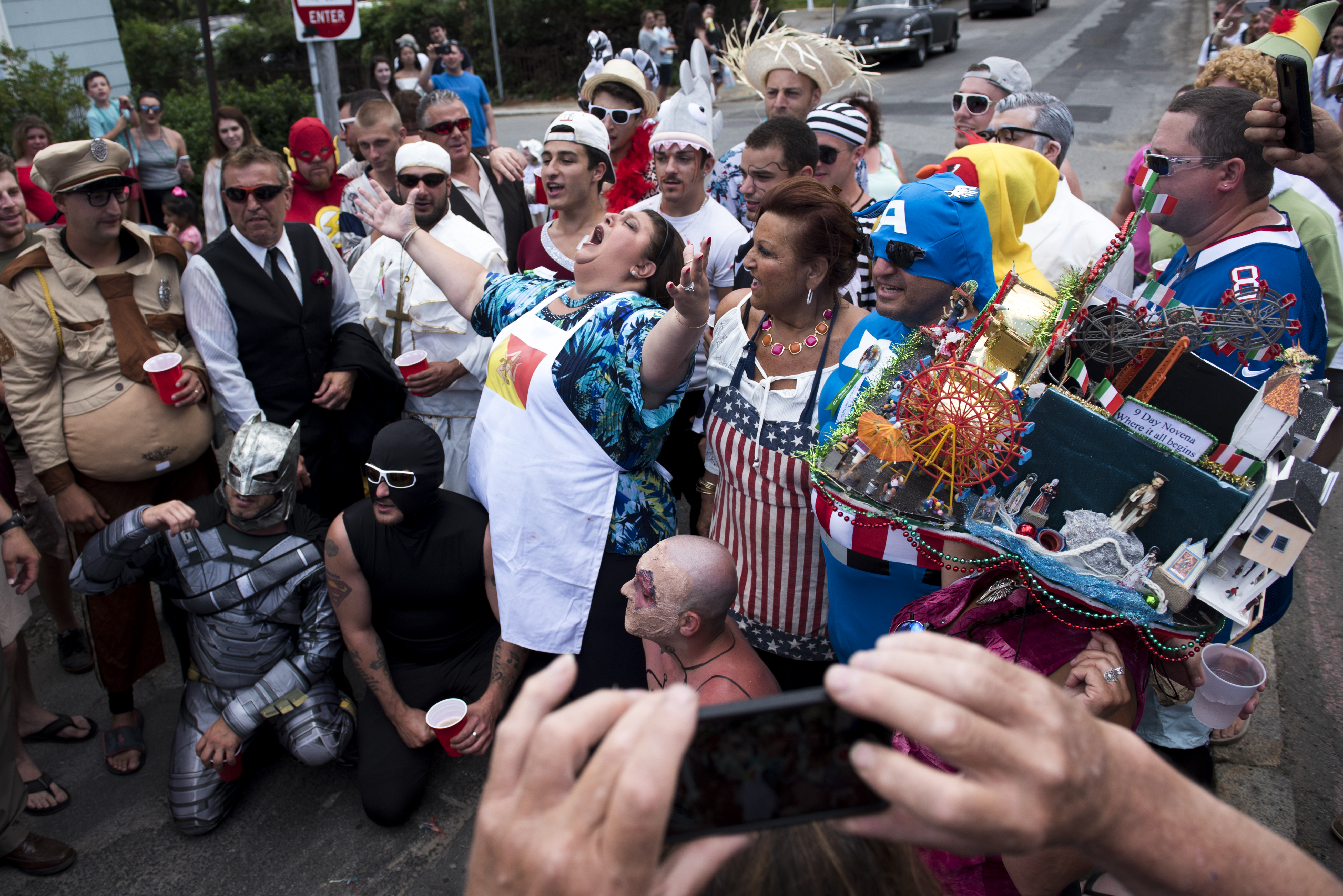 Gloucester Mayor Sefatia Romeo Theken leads a chant during the St. Peter's Fiesta.