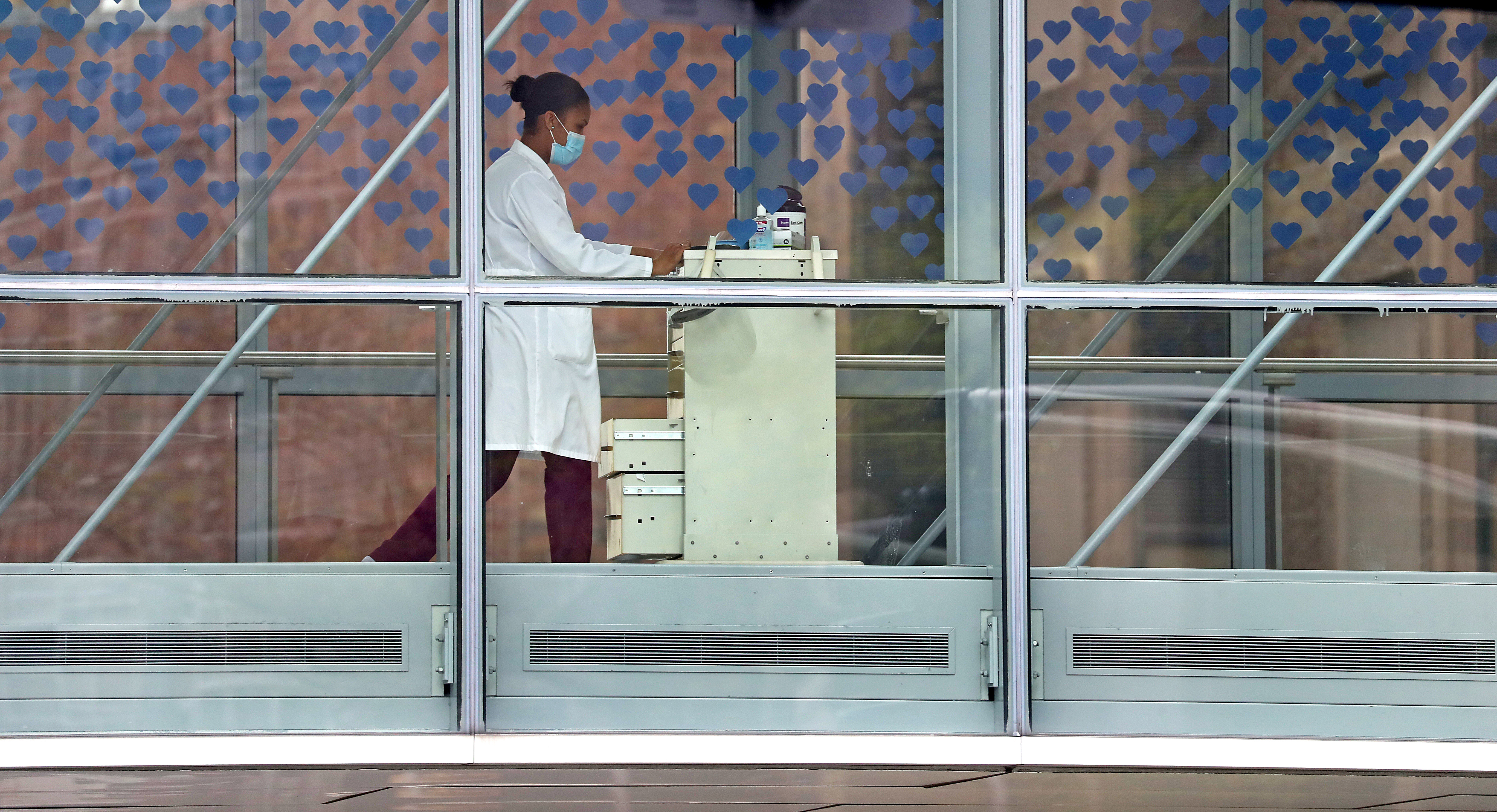 A medical staffer makes her way across a bridge at Brigham & Women's Hospital. A study shows there has been significant job growth in Boston's Longwood Medical Area.