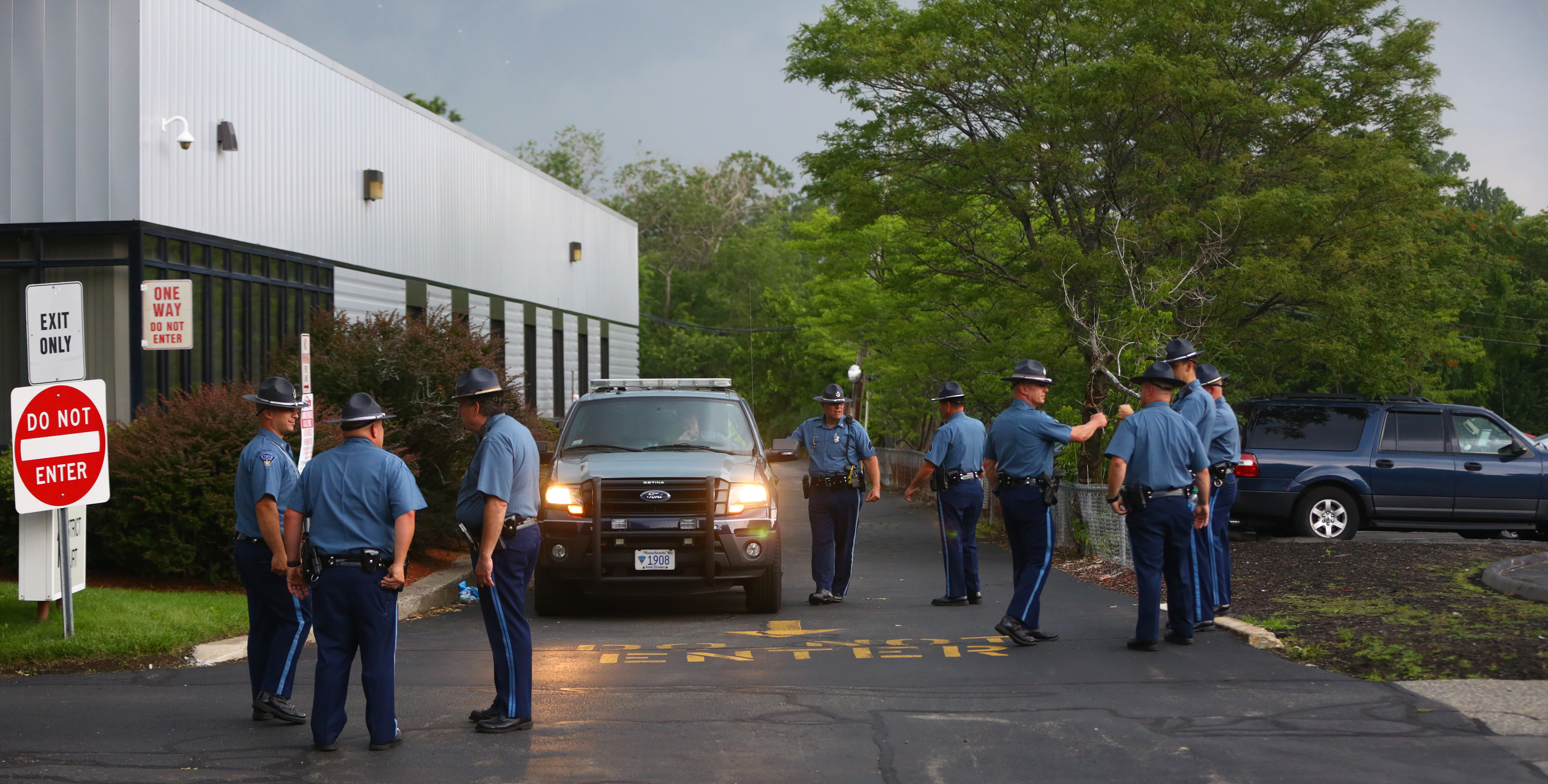 State Police troopers waited for the transport from Malden District Court of some of the men involved in an hours-long standoff with police.