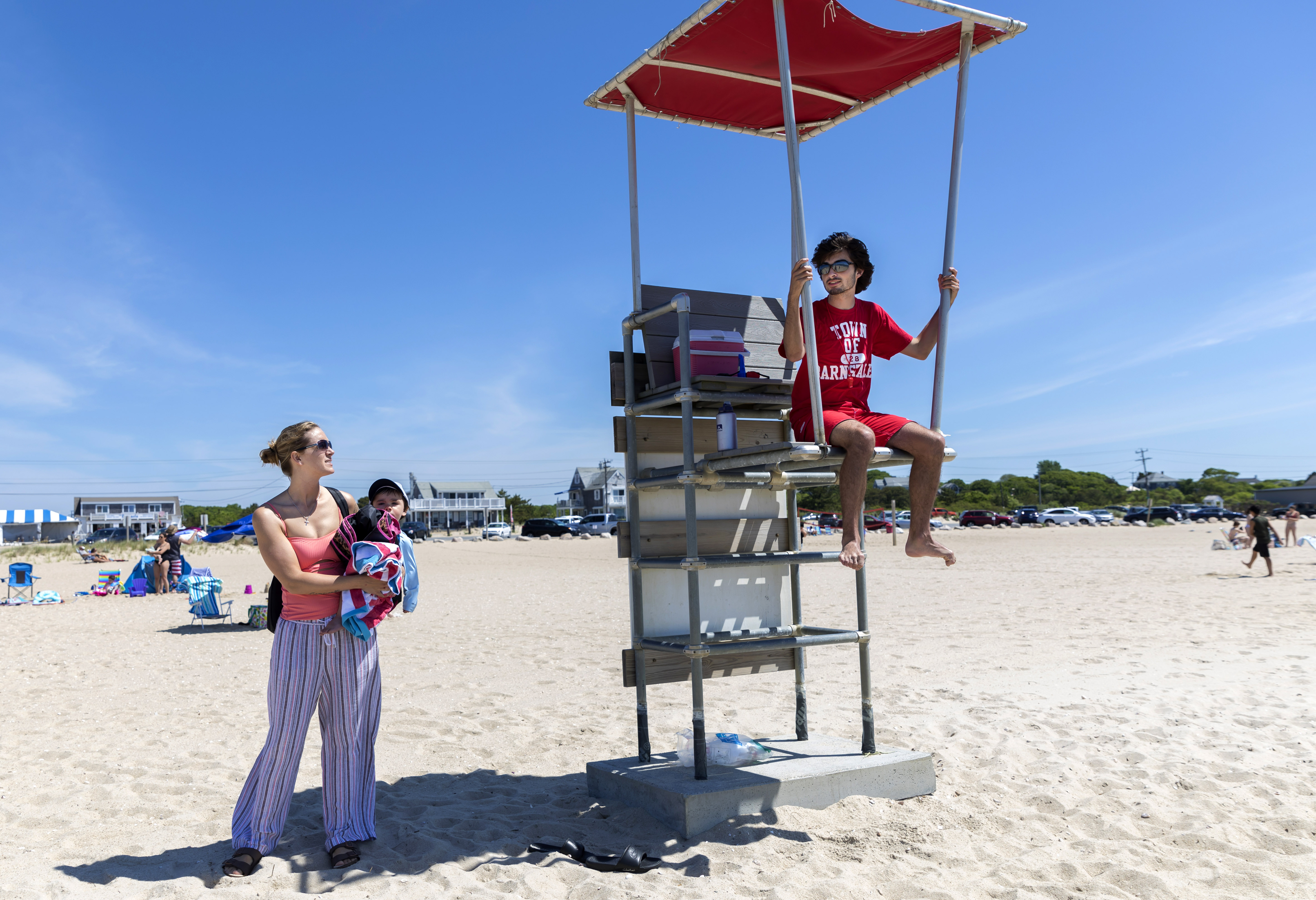 Craigville Beach lifeguard, Charlie Ewald, answered a question for beachgoer, Kara Bongiovanni, of Greenfield.