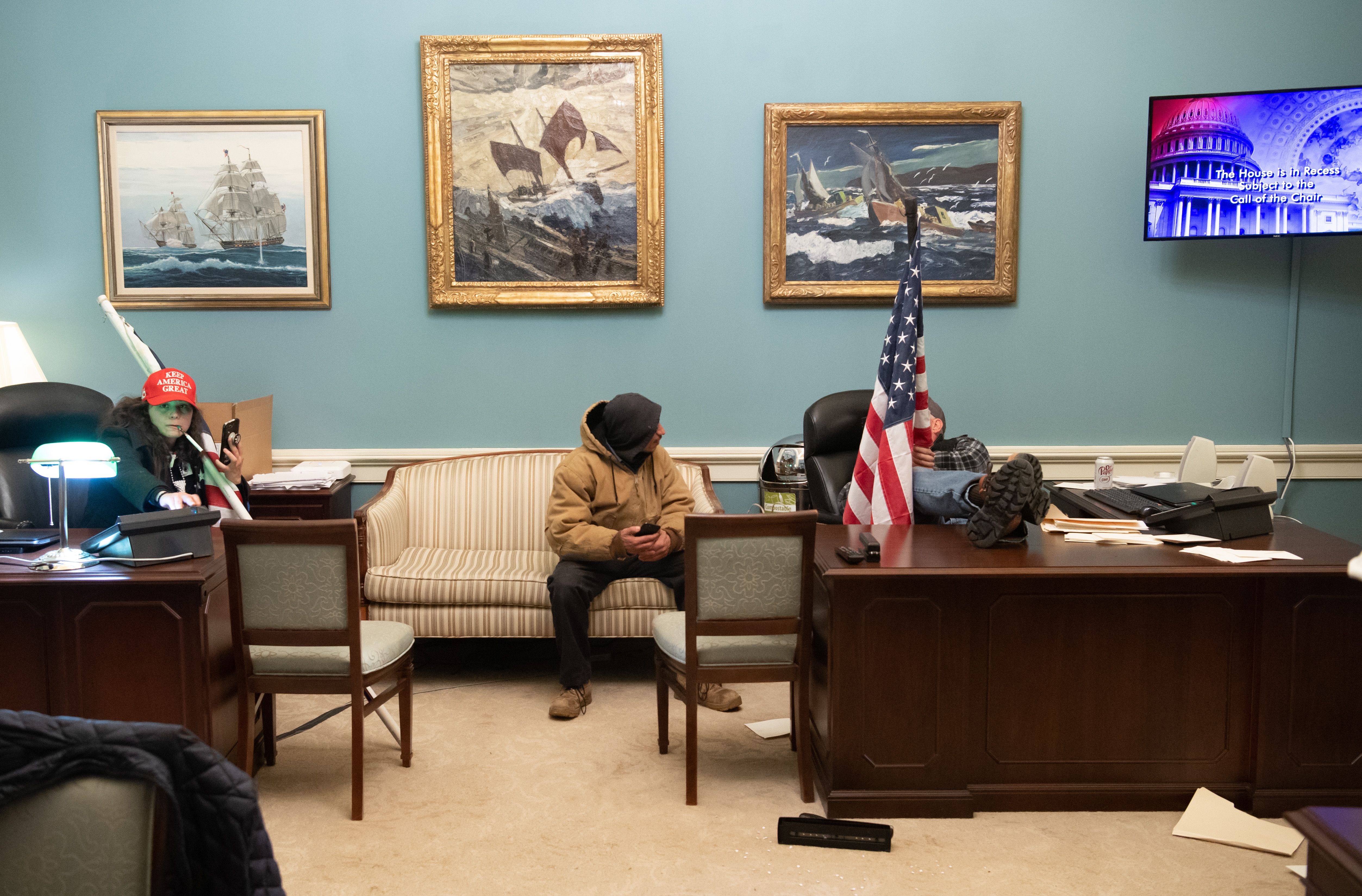 Supporters of President Trump sat at desks in the office suite of Speaker of the House Nancy Pelosi after breaching the US Capitol in Washington, DC, on January 6, 2021.
