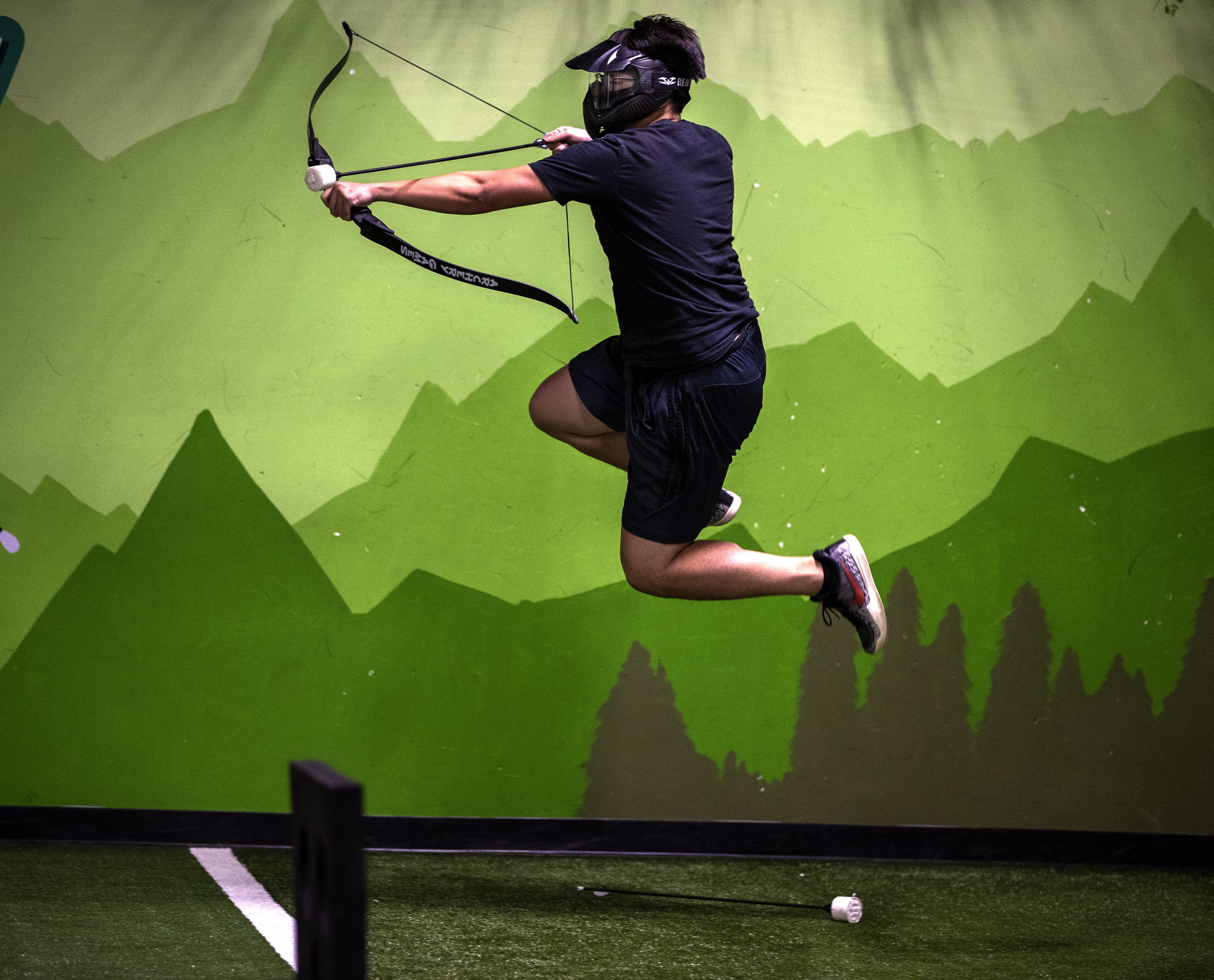 Ky Che does a flying shot during a game of combat archery at Archery Games Boston on March 3. The game is a combination of archery and dodgeball.