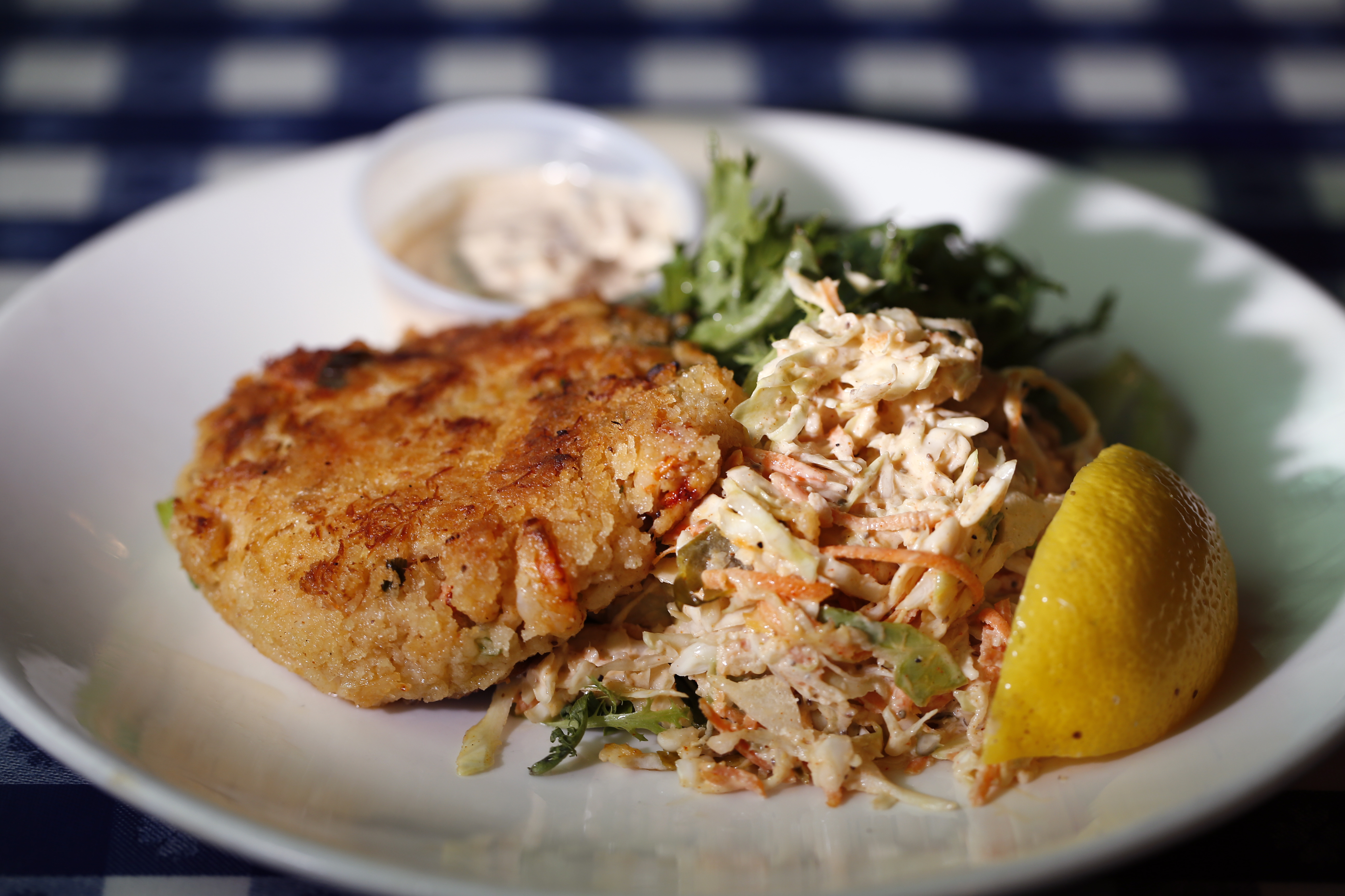 The crab cake snack with remoulade sauce and slaw at Summer Shack.