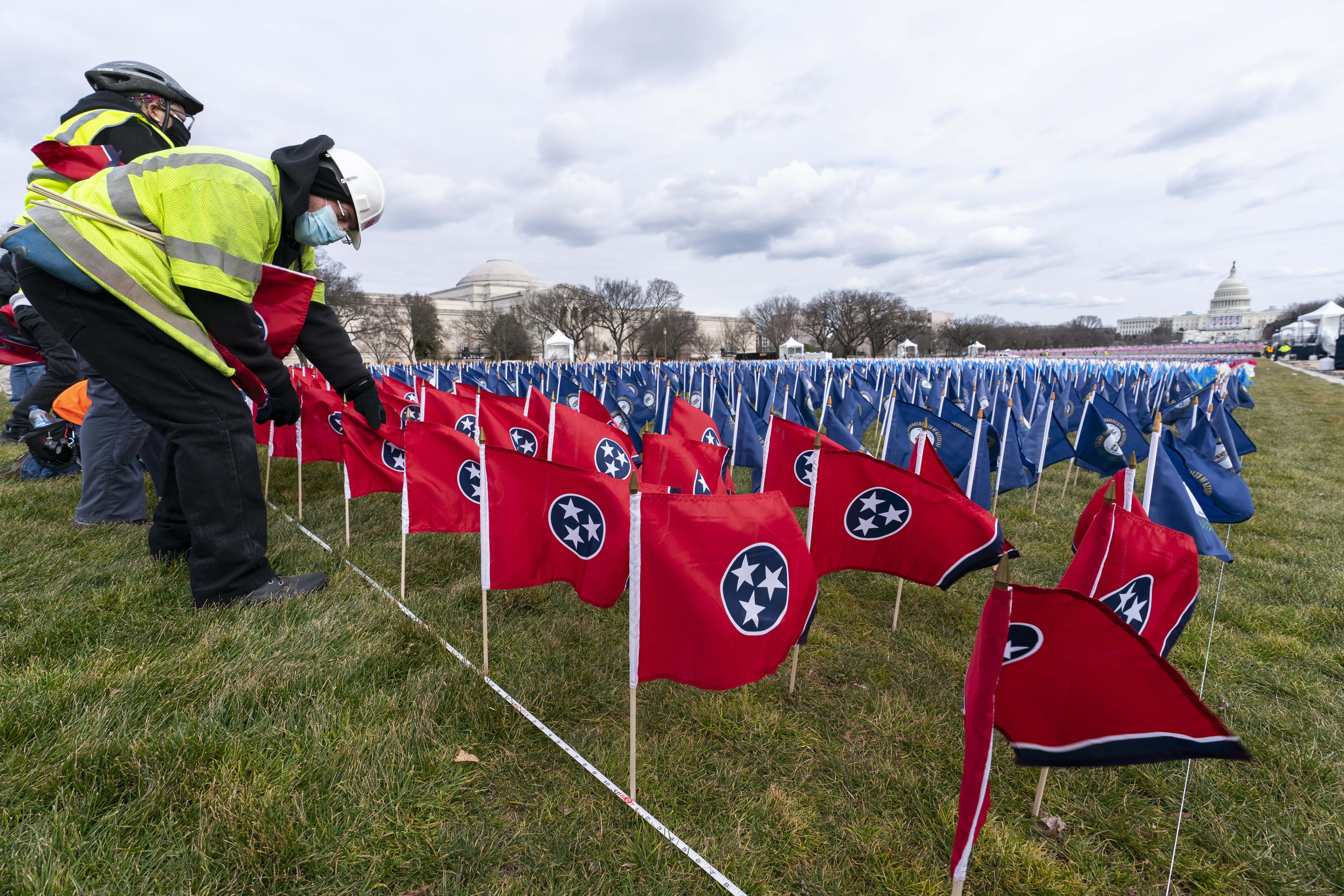 State flags including the Tennessee state flag, in front, are placed on the National Mall ahead of the inauguration.