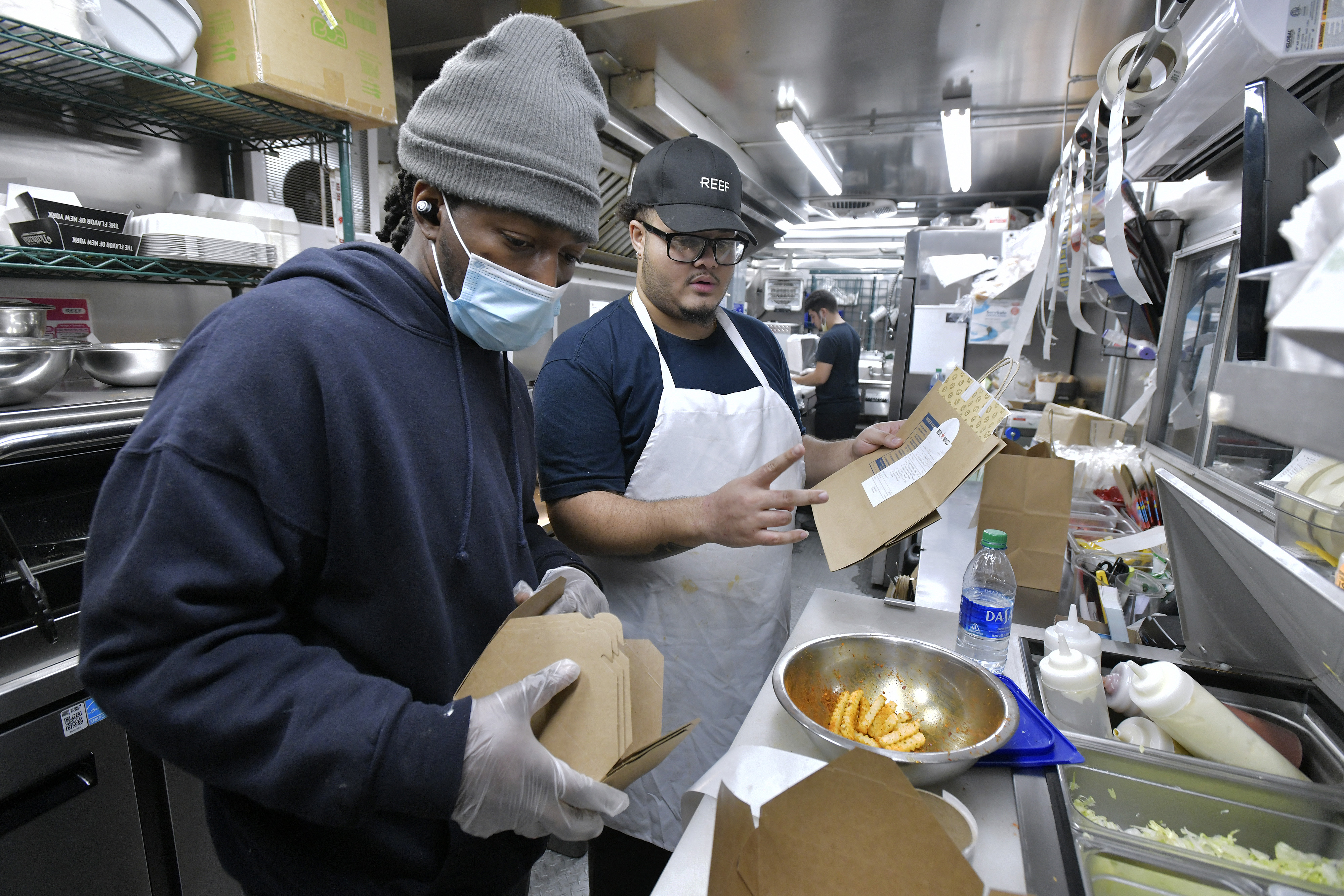 Line cooks Eddie Morgan and Jonathan Medina filled orders in of one of two Reef Technology delivery-only kitchens in Everett. 