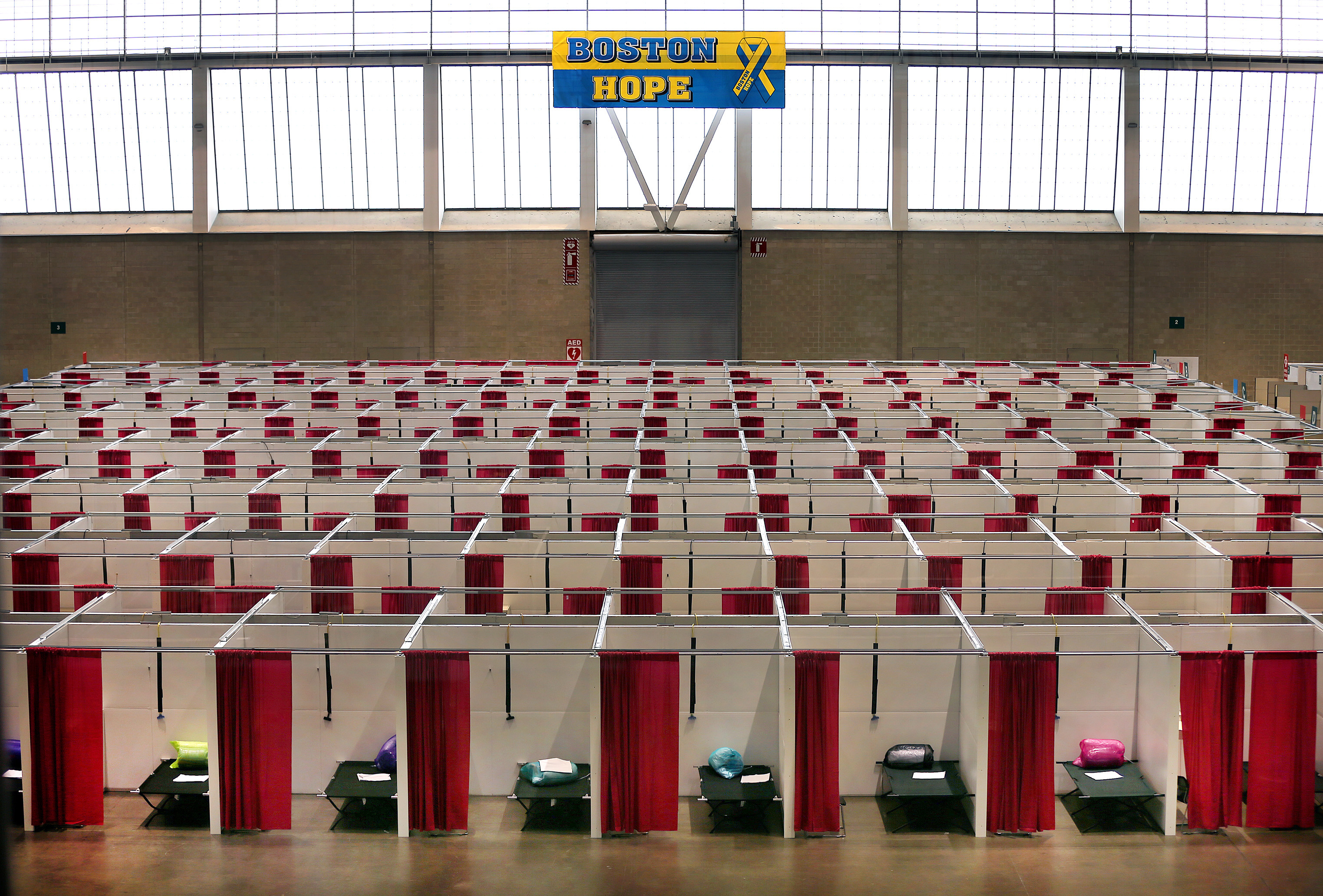 Boston- 04/09/2020- Hundreds of makeshift patient rooms were constructed using sheetrock which fill the huge floor of the Boston Convention and Exhibition Center to handle the number of coronavirus infected people that the city is expecting. Each room has military cotts, electricity and power. Photo by John Tlumacki/Globe Staff(metro)